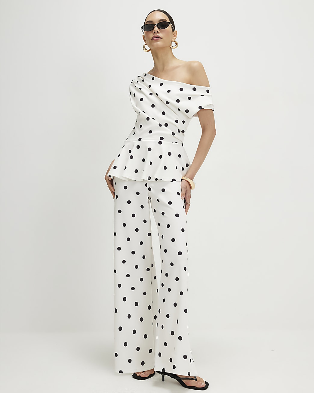 Cream Polka Dot Peplum Drape Jumpsuit | River Island UK & IE