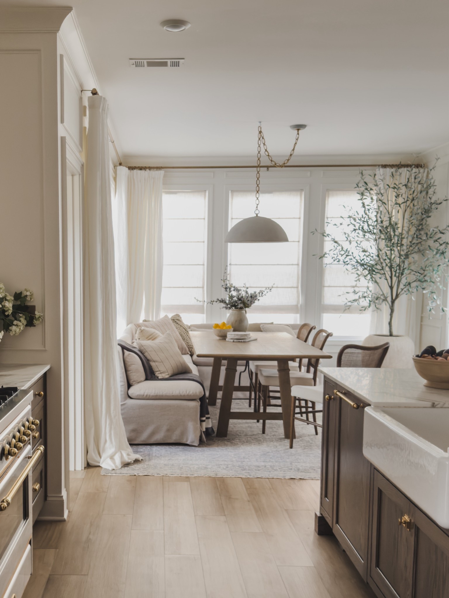 One of my must haves in my new home was a cozy breakfast nook complete with a banquette! This space transitions so nicely between my kitchen and living room plus offers great seating for everyone to gather around. 

Home finds, neutral home inspo, breakfast nook, collected style, swag lights, furniture favorites, neutral wood tones, dining chair, counter stool, banquette seating, dining table, neutral area rug, vintage style area rug, linen curtain, roman shades, brass detail, rich wood tones, faux florals, cozy throw pillow, Amber Lewis, Loloi, Wayfair, Arhaus, Home and Kids Co, Visual Comfort, Pottery Barn style, Two Pages, shop the look!

#LTKHome #LTKSeasonal