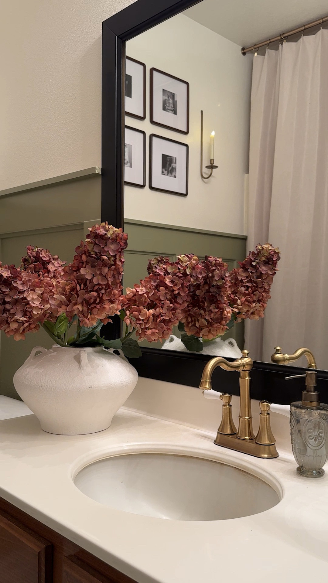 EP 2 | IT’S REVAL DAY!

Welcome to day 2 of building my amazing mama her dream bathroom. Last week we added panel molding and it completely changed the space. This week? Paint, tile, and all the cozy vintage details she loves.

We went with the prettiest shade of green on the bottom half, creamy white on top, and it already feels like a different space. For the floors, I skipped the budget-busting tile and went with a vintage black + white peel & stick.

I swapped in new vanity knobs, glass door handles, brass sconces, fluffy towels… and a little gallery wall of her pets (plus Sammie, obviously). & I’m sharing my hack for hiding an ugly shower door.
.
.
.
#BathroomMakeover #VintageBathroom #DIYHomeProjects #HomeDecorInspo #SmallBathroomIdeas #VintageHomeDecor #CozyHomeVibes #DIYBathroomRenovation #BudgetFriendlyHome #PeelAndStickTile #PanelMolding #HomeRenoInspo #NeutralHomeDecor #BeforeAndAfterHome

#LTKHome #LTKHome