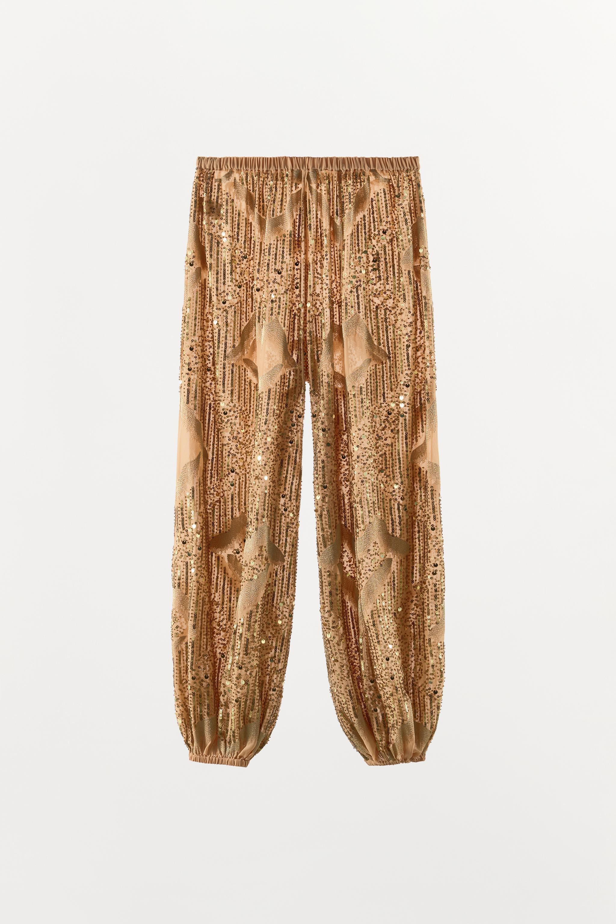 Model height: 173 cmMid-waist trousers with an elastic waistband. Featuring metallic thread detai... | Zara UK