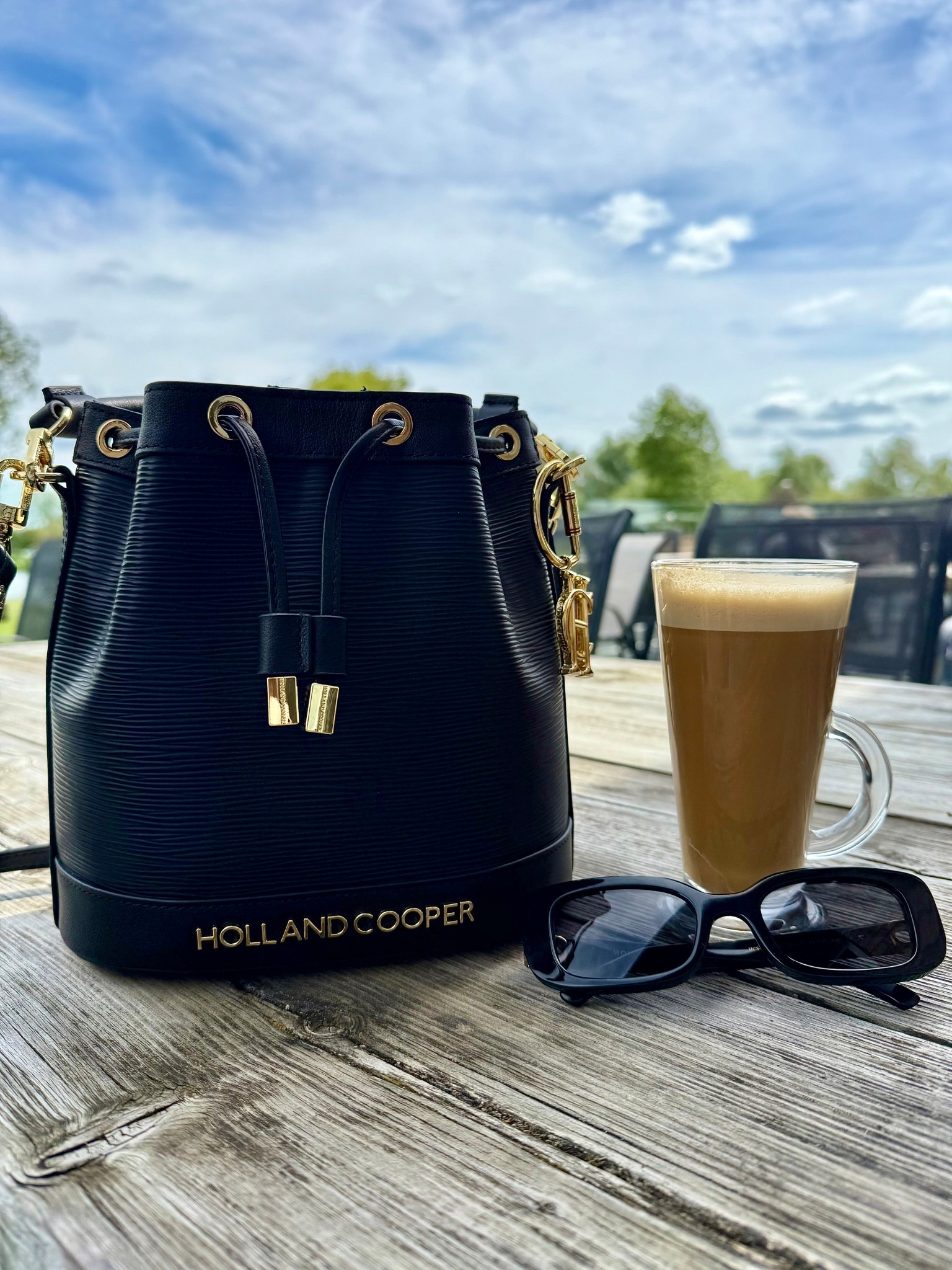 I have a handbag & sunglasses addiction! I can’t help it. And yes I use all of them. I like to wear a lot of black, it’s chic & timeless. So I do like black sunglasses & purses. I liked this bucket bag as it’s lightweight enough for summer, it’s smaller than I usually go for, however I can fit loads in it, & I carry a lot! I’ve also added an HC Keyring as a bag charm. 
I thought the Paris sunglasses went well when worn together with the bag. They’re a slimmer line frame is comfortable to wear all day. 
You can also get the bag in rattan finish & the sunglasses in tortoiseshell. 

Holland cooper, luxe, luxury, British, U.K blogger. 



#LTKbag #LTKsummer #LTKluxury