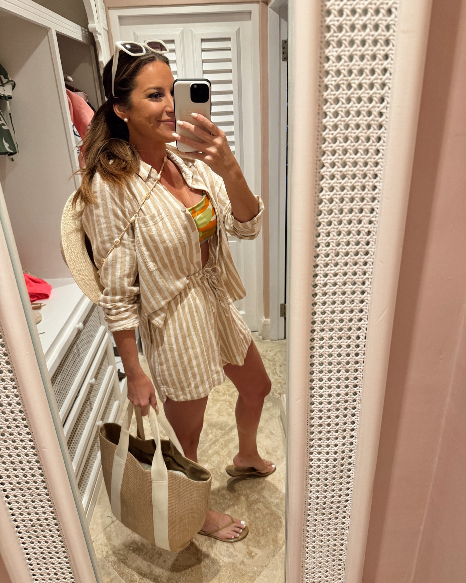 In a small button down long sleeve shirt and small matching shorts, medium bikini top, large bottom, tote, seashell strap fedora, sunglasses and accessories for beach resort outfit - all fits TTS.

#LTKstyletip #LTKSeasonal #LTKswim