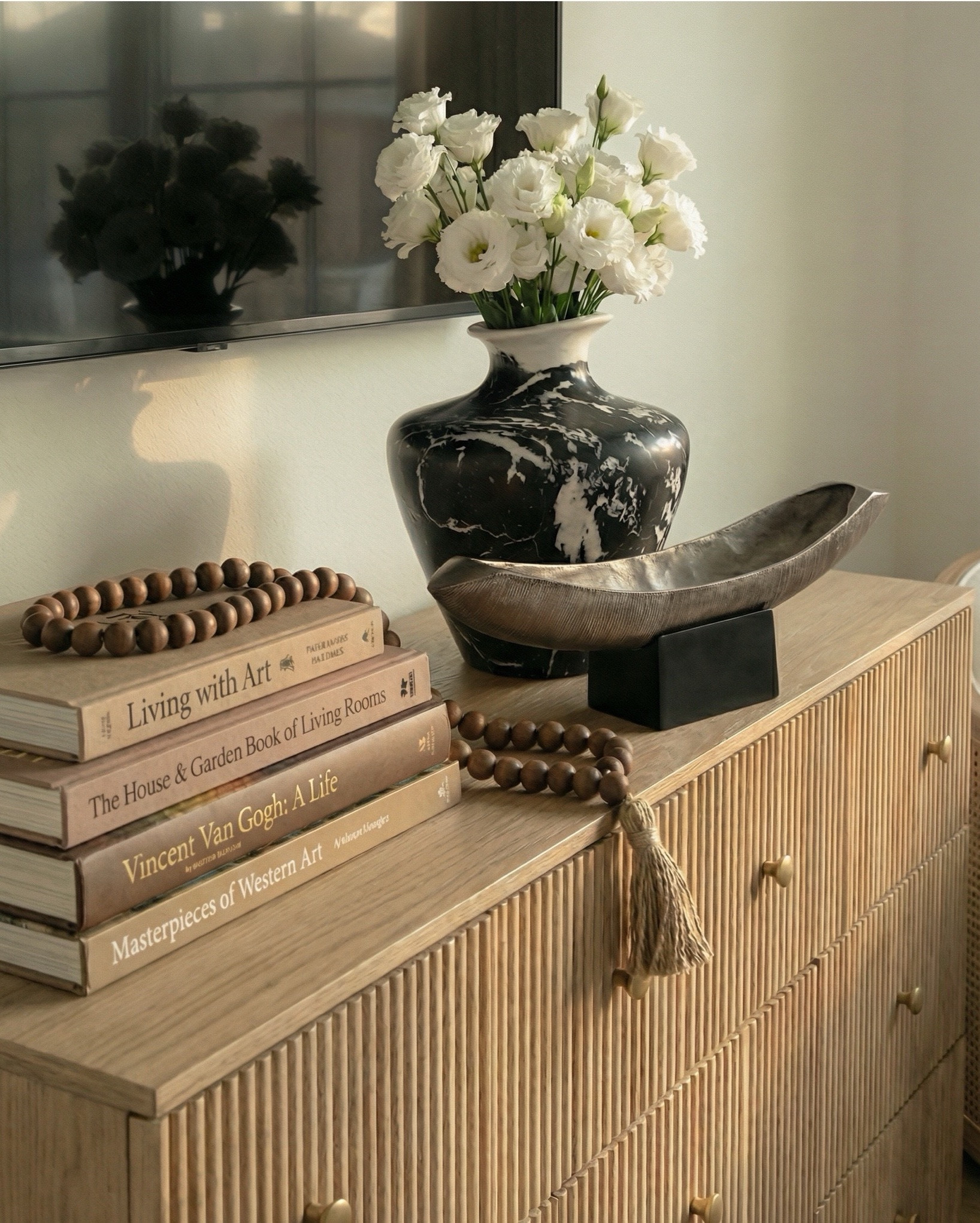 Shop the look:
* Wood canopy bed 
* Brown leather upholstered bench
* Brown knitted blanket
* Brown throw pillows
* Brown wood 3 drawer nightstands
* Wall art
* Glove wall lights
* White tree planter
* Black vase
* Black table lamp
* White decor bowl
* Decor books
* Wood dresser
* Brown traditional rug 
* Wood decor beads
* Wood upholstered swivel chair
* Wood end table
* Green runner rug 
* Faux olive tree

#LTKsale #LTKhome #LTKstyletip