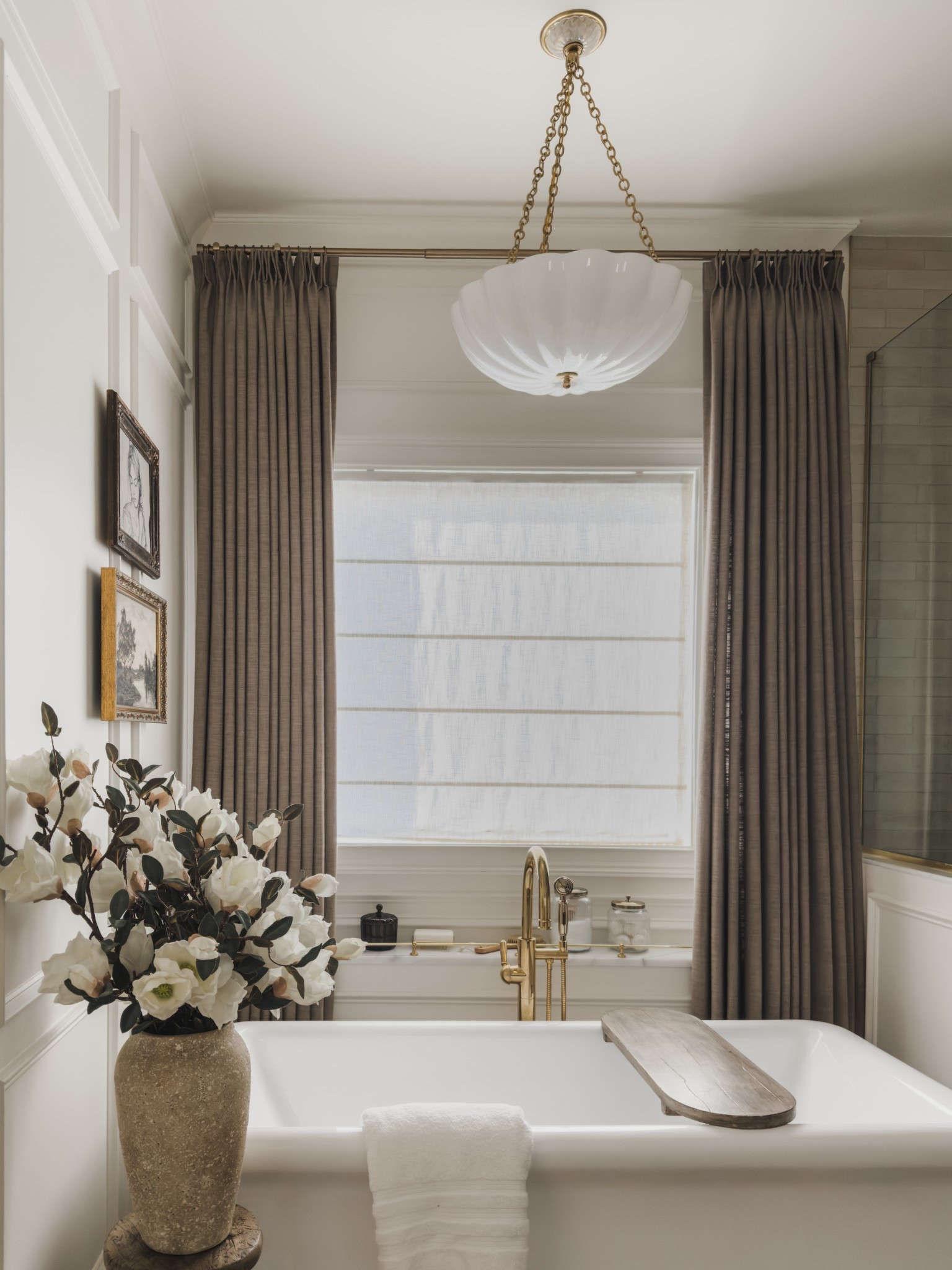 Primary bathroom details showcasing this stunning freestanding soaking tub, this gorgeous oversized chandelier with a frosted glass and brass detail, and rich linen curtains in a stunning brown shade to elevate my primary bathroom space.

Home finds, neutral home inspo, primary bathroom inspo, collected style, bright and airy, brass detail, linen shades, freestanding tub, faux florals, wooden bath tray, brass railing, vintage style art, chandelier details, wooden stool, Two Pages, Wayfair, Perigold, Afloral, Pottery Barn style, Etsy, Target style, McGee and Co, shop the look!

#LTKHome #LTKSeasonal