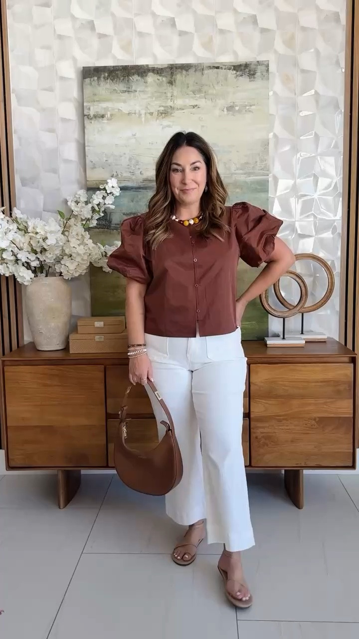 The prettiest puff sleeve top for a day out 🤎 I love the rich rust color and how the structured sleeves dress it up — paired with white wide-legs and slide sandals it's such an easy summer-to-fall look. Added a woven tote to keep it light and breezy. 📏 Wearing Lin the top, tts L in the jeans 

 #LTKstyletip #LTKfindsunder50 #LTKSeasonal #LTKOver40 #LTKMidsize