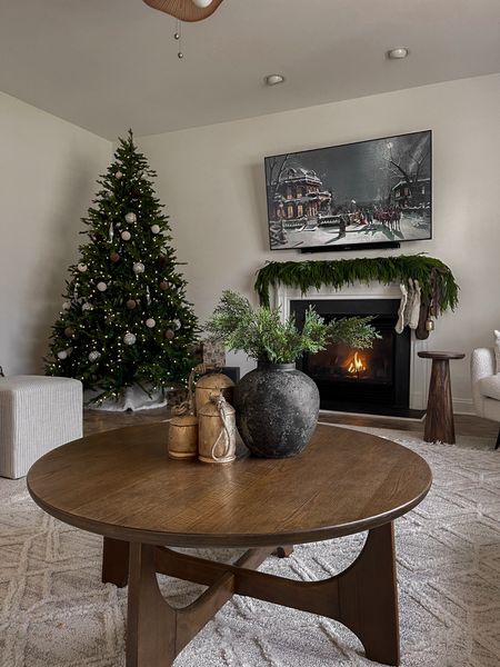Christmas decor, Christmas tree, artificial tree, round coffee table, Christmas bell decor, hobby lobby, ottoman, layered rugs, fireplace mantle decor, garland for mantle, neutral stockings, neutral Christmas decor, living roomm#LTKHoliday 

#LTKhome #LTKSeasonal