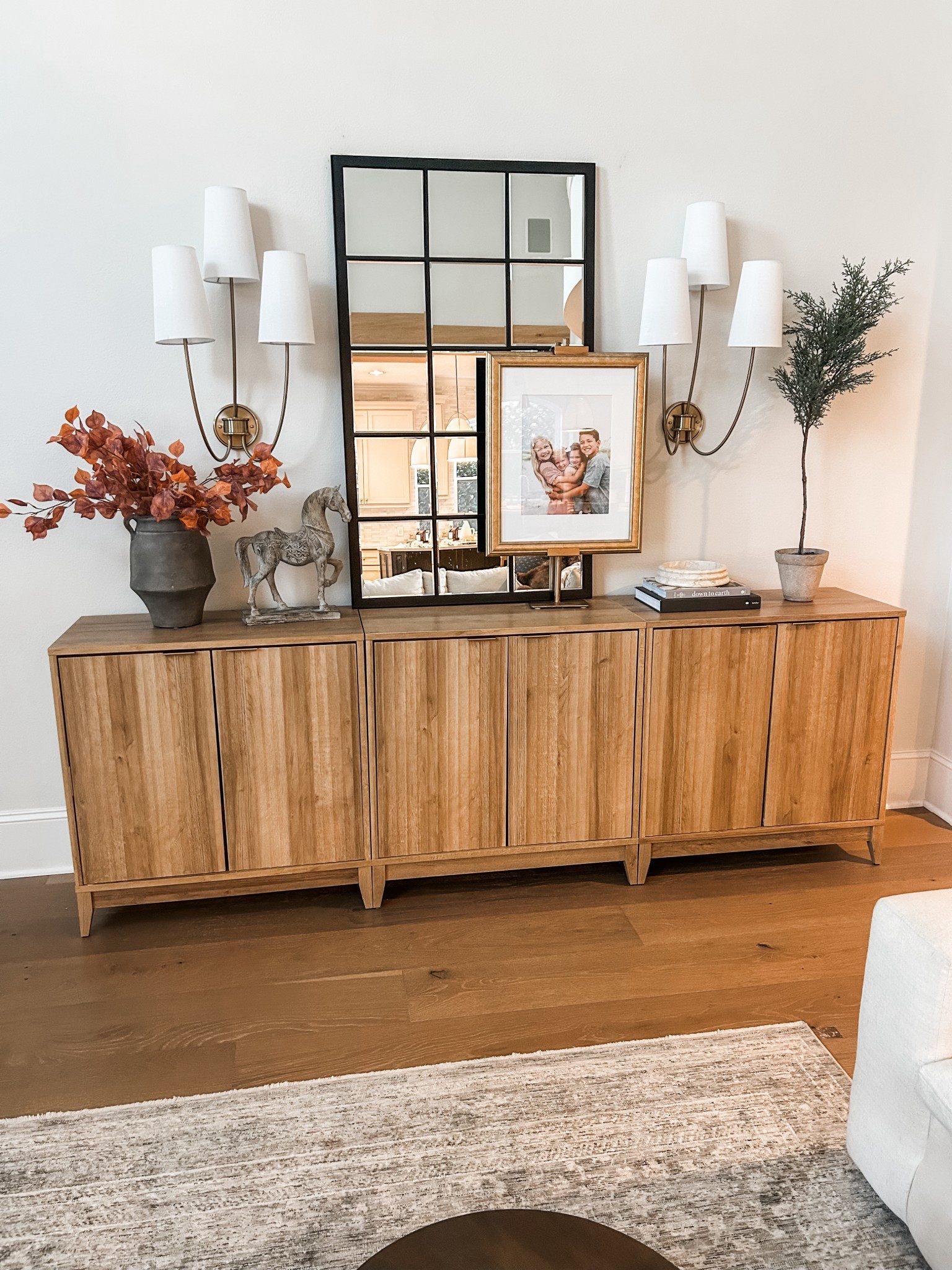 Easy updates to our Amazon cabinets. I’ve always felt like the framed photo needed more height, so this easel was perfect! I bought the cheap black on, and put a quick layer of rub n buff on it. 





Side board, storage cabinet, large mirror, fall stems, sconces 