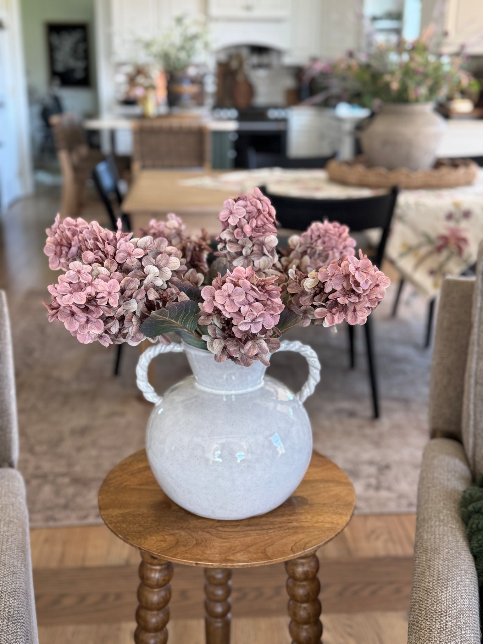 The prettiest cone shaped hydrangeas with my favorite vintage inspired ceramic vase with rope handles. My solid wood accent table is currently on sale and comes in a few different finishes. Also sharing my colorful dining table square and neutral area rug with shades of cream, beige and browns  

#LTKHome #LTKSaleAlert
