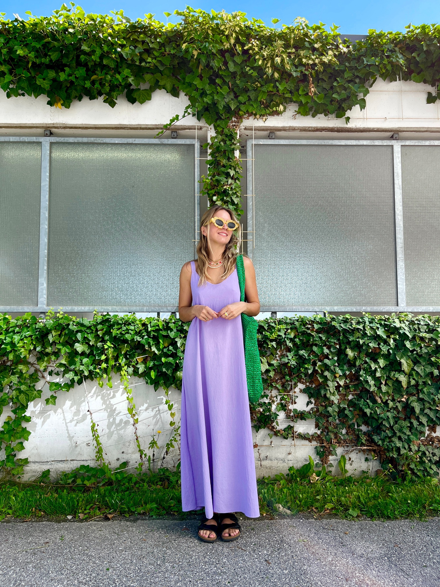 Maxi Dress. Fashion Blogger Girl by Style Blog Heartfelt Hunt. Girl with blond hair and bow hairstyle wearing a purple maxi dress, yellow flower sunglasses, green straw bag and Birkenstocks. #maxidress #purpledress #summerdress #colorfuloutfit #colorfulstyle #colorfulfashion #colorfullooks #fashionfun #cutesummeroutfit #summerfashion2023 #summerlookbook #fitcheck #dailylooks #dailylookbook #contentcreator #microinfluencer #discoverunder20k #outfittok #fashiontok #dailytok #ootdtok #styletok
