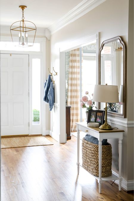 Our entryway features a side table, mirror, lamp, coat rack and basket for storage .

#LTKhome