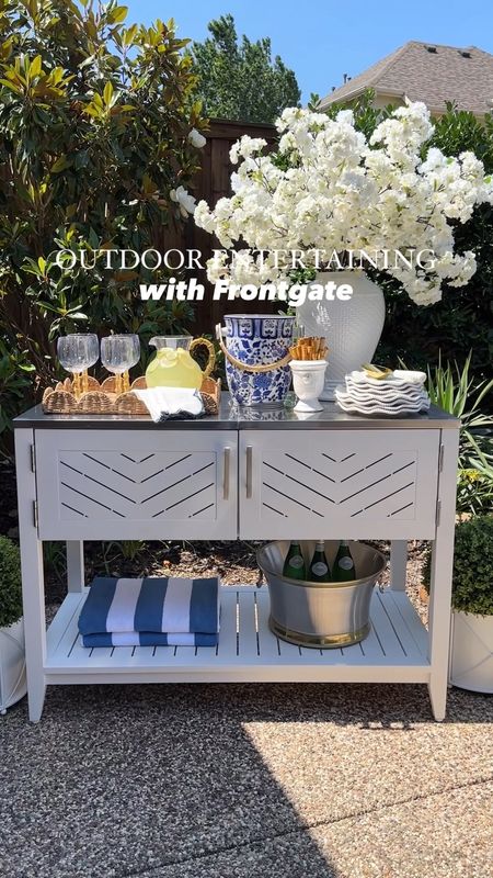 Welcoming patio season with these beautiful new additions from @frontgate! ☀️ #frontgatepartner My new outdoor serving console is absolutely perfect for effortless entertaining and elevating any patio space! Not only does it feature a removable beverage tub, but it also has plenty of storage space for entertaining essentials. I also grabbed this gorgeous mixed metal beverage tub for chilling drinks as well as these amazing quality boxwood balls for a beautiful finishing touch! 😍 I can’t wait to host some fabulous summer gatherings! I’ve linked these items and more must-haves from Frontgate! #frontgate




Outdoor, patio bar, patio console table, outdoor set up, white cabinet, poolside, coastal decor blue and white decor blue and venue striped beach towels cherry blossoms scallops tray ginger jar ice bucket bamboo flatware grandmillennial decor coastal decor realistic boxwood balls faux boxwood 

#LTKSaleAlert #LTKFindsUnder50 #LTKHome