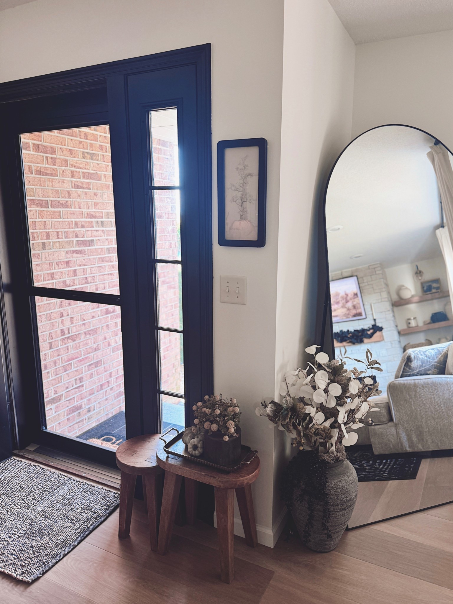 Small corner, big cozy vibes ✨🍂 A pair of wood nesting tables, moody stems, and neutral fall textures make this entry feel warm + welcoming without overstyling. Linked everything so you can recreate the look! #LTKhome #NeutralDecor #FallHome #EntrywayDecor