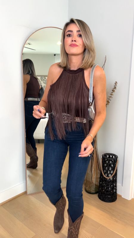 Rodeo season is here! Loving this fringe bodysuit def adds a fun western touch! Wearing a medium. My jeans have been my fav lately, so stretchy and very high rise and flattering! Fit tts and I’m wearing the long length (5’8). The rhinestone belt adds the perfect sparkle and the silver bag goes great with tear brown shades! My jewelry is 10% off with code Janie, I’m obsessed with Melinda Maria! Boots are super old but I’m liking some new styles. 