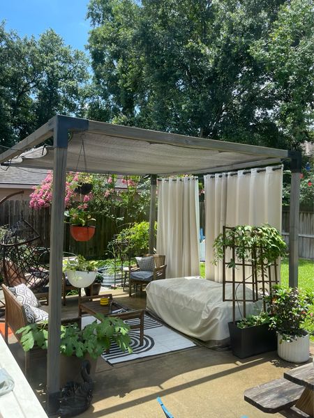 Now that Summer is in full swing we need all the shade and outdoor comfort we can get! I decided to hang some waterproof outdoor curtains to help protect the family from UV rays while hanging out outside in the backyard. The curtains can be drawn back at tied to the pergola posts or fully extended to provide privacy from neighbors and shade over our outdoor bed. I’m using 4 52-84” panels to fit the 12’ side of the 10’x12’ pergola  In the far corner I’ve tucked an egg chair because it’s always fun to hang in swing seat. 

Related outdoor decor also linked large planters hanging plant baskets outdoor rug patio set

#LTKSeasonal #LTKHome