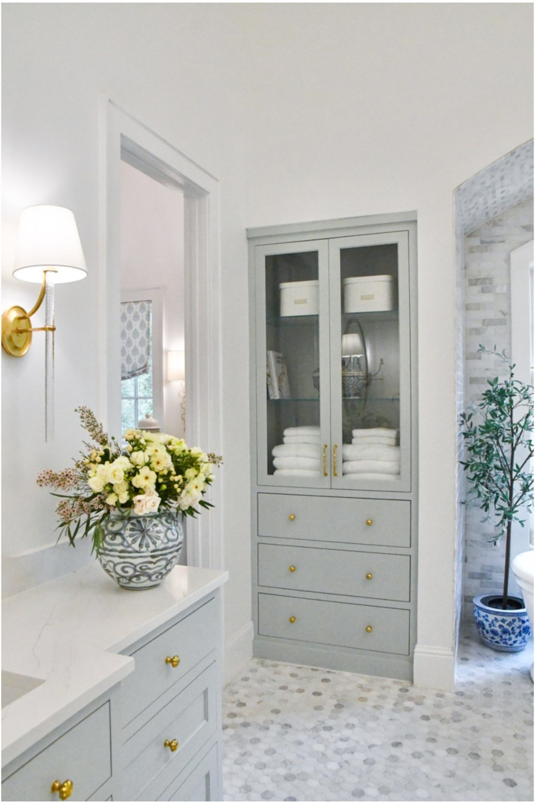 Primary bathroom home decor 
High quality towels
Light sconces 
Blue and white vase 
Olive tree 

#LTKHome