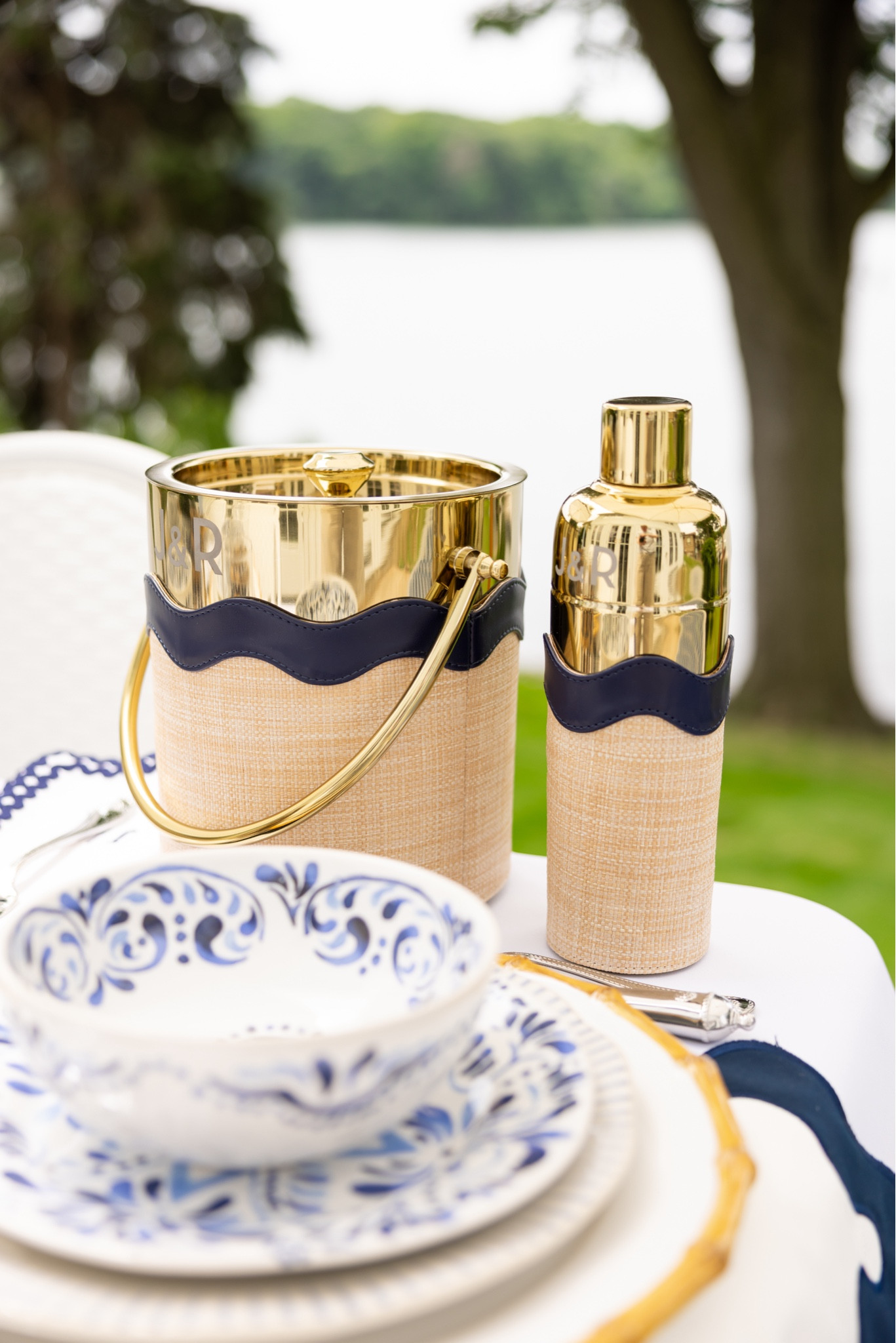 The perfect ice bucket and cocktail shaker. The raffia and navy scalloped detail are everything, and I love it can be monogrammed!

#LTKParties #LTKHome #LTKSeasonal