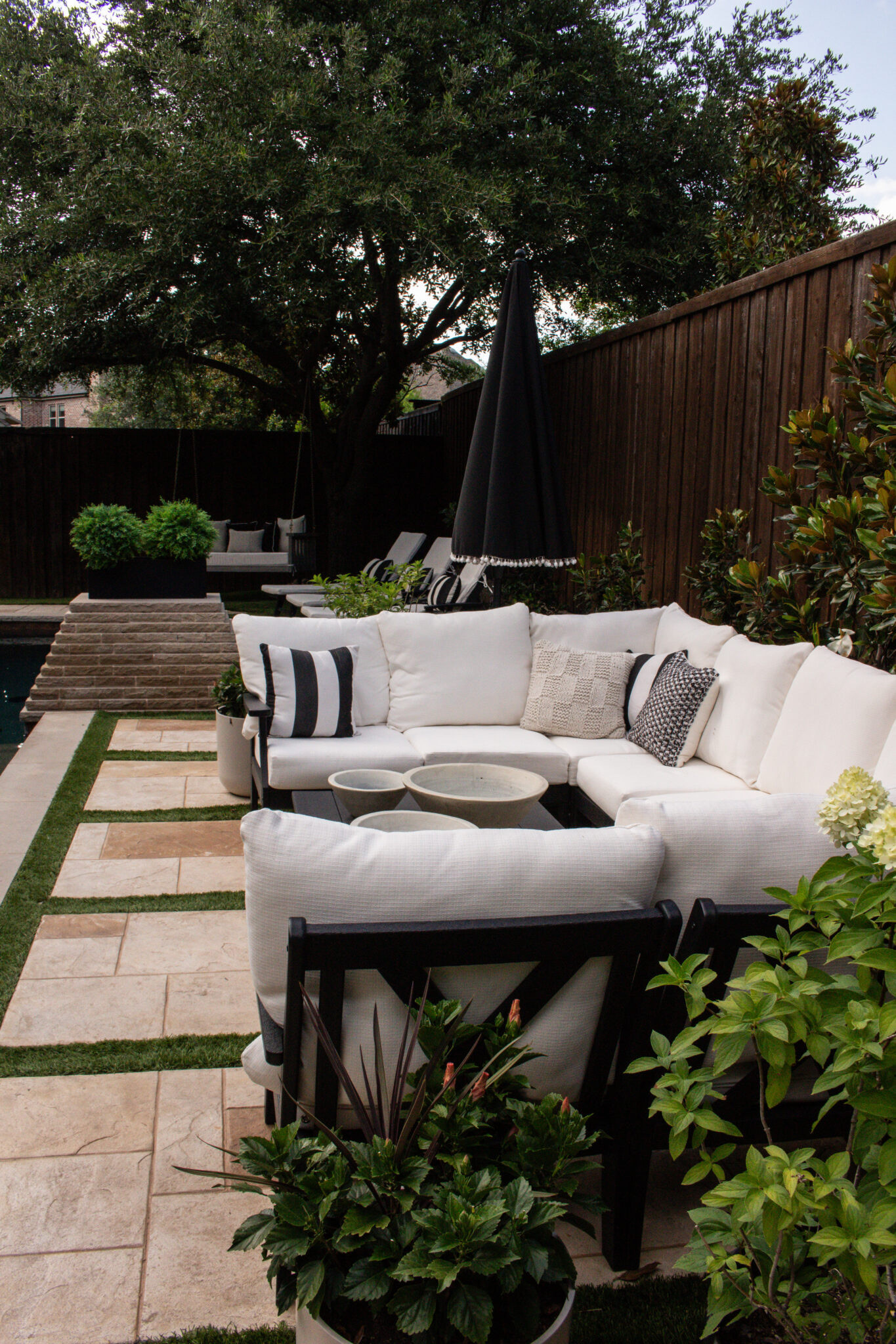 This backyard is proof that a simple black and white color palette never goes out of style. Classic outdoor furniture, cozy conversation areas, beautiful planters, and functional entertaining spaces make this one of my favorite outdoor designs.

#LTKSeasonal #LTKHome