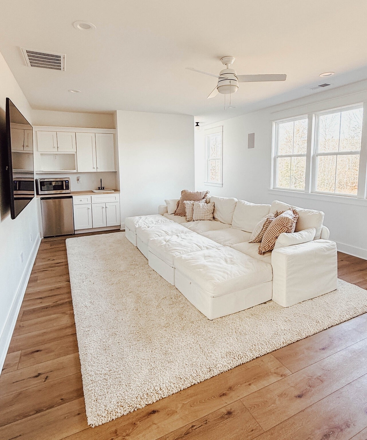 Huge, comfy sectional with four ottomans and tons of storage, plus the COZIEST rug you’ve ever stepped on. Perfect for a family room, movie or rec room!! 

#LTKHome
