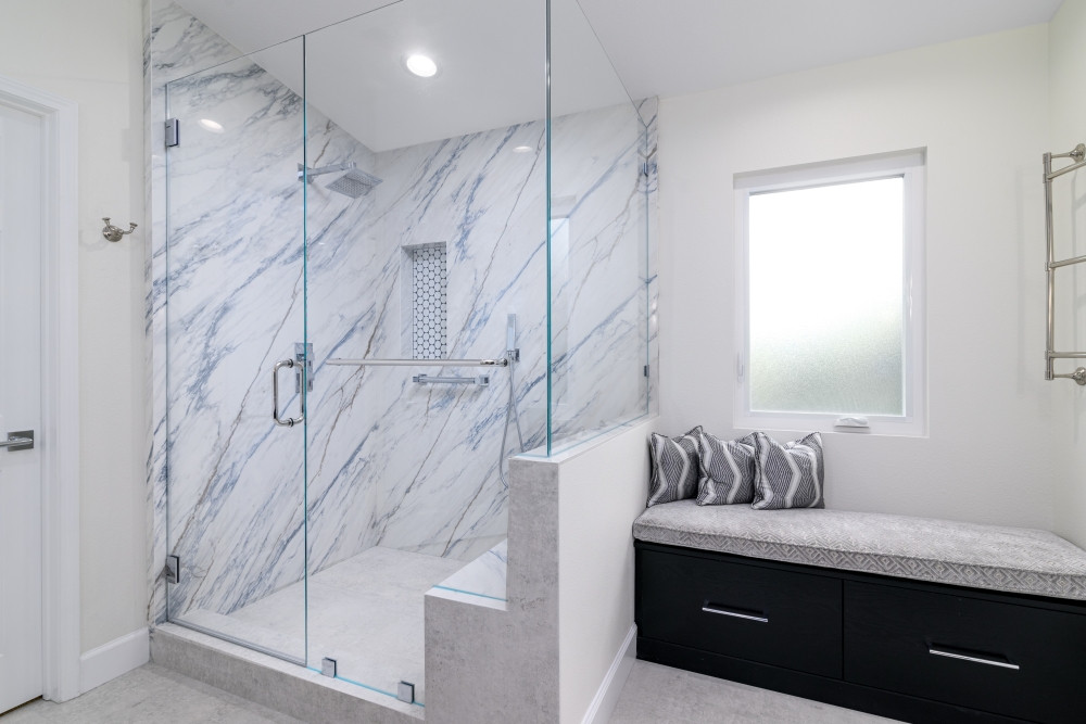 A beautiful slab wall shower with a custom black bench with storage drawers adds both function and style to this bathroom remodel! Topped with a light gray cushion and pillows that match the shower wall material, this cozy seating nook blends seamlessly with the space.

#BathroomDesign #BathroomRemodel #CustomStorage #InteriorDesign #ModernBathroom #LuxuryBathroom #BuiltInBench #FunctionalDesign #BlackBench #CustomCabinetry #ShowerDesign #BathroomSeating #DesignDetails #TimelessInteriors #HomeRenovation #LTKinteriors #DreamBathroom #StorageSolutions #StatementSeating #HomeInspo 

 

#LTKHome