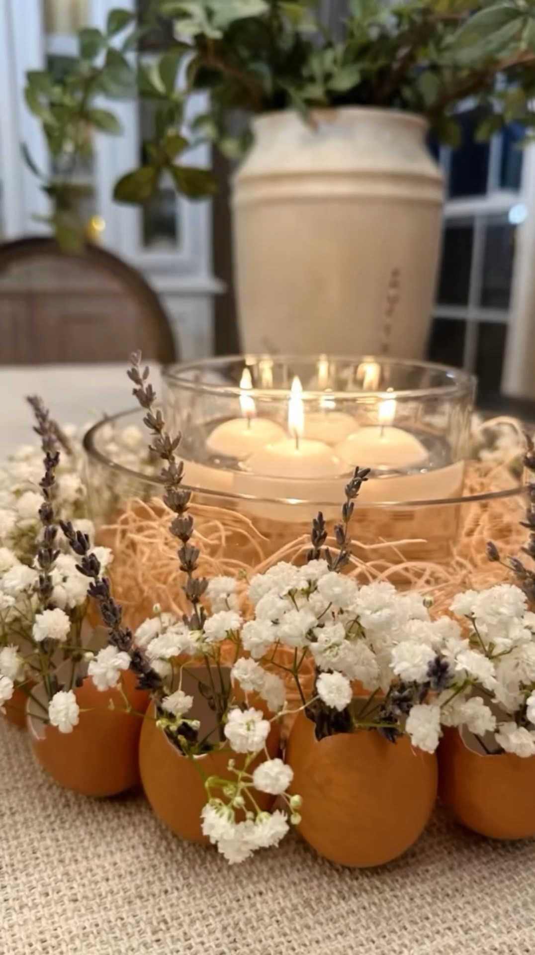 DIY Eggshell Floral Candle Wreath   🤍 is a charming and fun way to create a Spring or Easter themed centerpiece. Transform your everyday egg shells into a beautiful and unique display. It’s a simple but elegant way to infuse the spirit of the season with a homemade touch! 

Materials I used:
* 12-15 eggshells (collected from regular egg consumption)
* Glass bowl
* Hot glue gun
* Babies breath and dried lavender 
* Basket straw
* Small glass vase
* Water
* Four small, white floating candles

Instructions:
* Collect 12-15 eggshells / this took me a little over a week, ensuring they are not damaged beyond a small opening at the tip during cracking.
* Wash and let the eggshells dry completely.
* Trim the openings of the eggshells to create mini vases.
* Trim and arrange the eggshells to achieve the desired aesthetic. 
* Use a hot glue gun to secure each eggshell to the front of a glass bowl, forming a wreath-like arrangement.
* I chose Baby’s Breath and dried Lavender for a rustic look, placing them in the eggshell vases.
* In the center of the bowl, add basket straw for texture.
* Place a smaller glass vase in the center, fill with water.
* Add four small, white floating candles to the small vase.
* Arrange the candles and florals to create a cohesive and charming centerpiece. Enjoy your DIY Eggshell Floral Candle Wreath for a delightful touch of Spring or Easter in your home!

#LTKStyleTip #LTKHome #LTKSeasonal