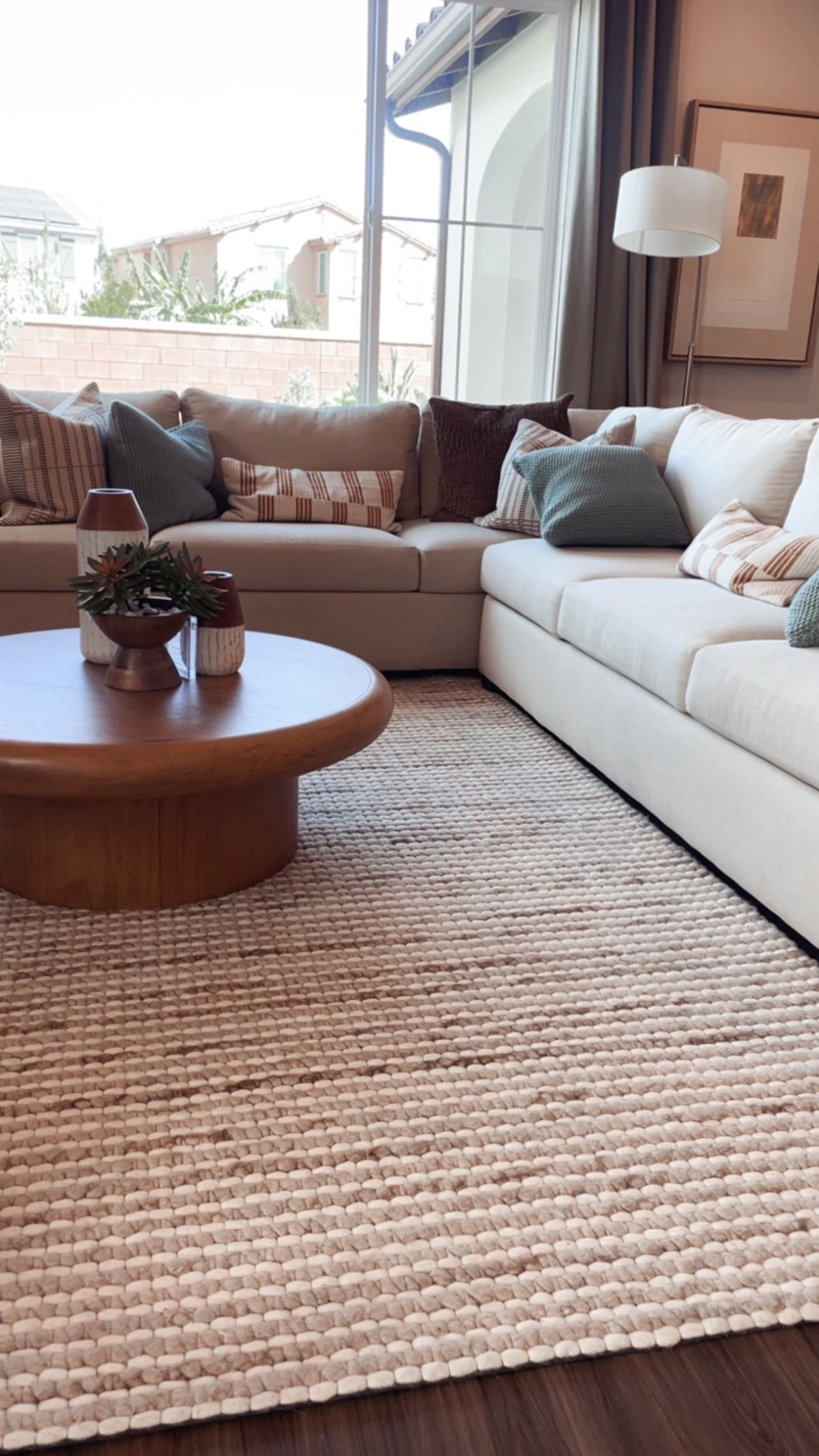 Living room with the Zack large round coffee table, the Mod sectional from Ashley Homestore, and a neutral wool area rug. Plus lots of fun toss pillows! 

#LTKSaleAlert #LTKHome #LTKselfcare