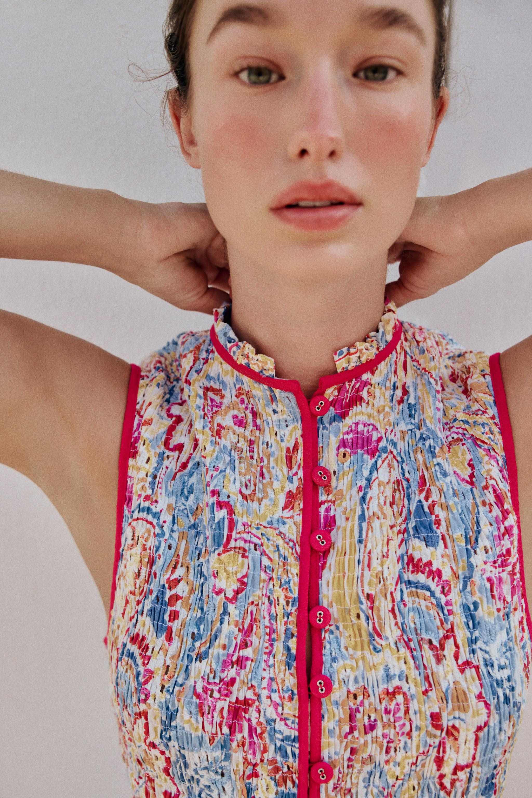 Ruffled collar sleeveless top. Features smocked elastic detailing and openwork embroidery. Front ... | Zara US