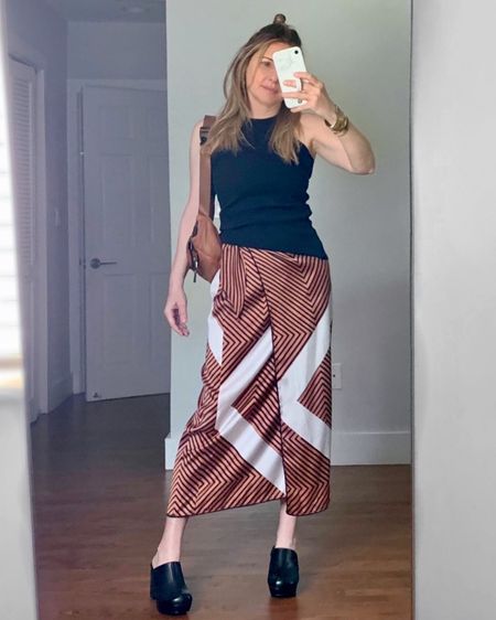 Work outfit: midi print skirt with a cutaway tank and clogs. I’m wearing it with my Caraa sling bag but a black shoulder bag would dress the outfit up. 

#LTKshoecrush #LTKstyletip #LTKworkwear