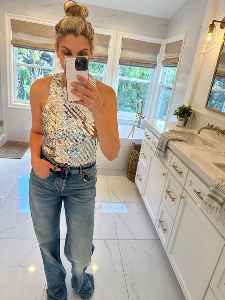 This silver sparkly tank is giving all the New Years vibes 🪩🎉 It’s the Intimately Free People Disco Fever Cami & has the cutest bow that ties on the back! It also comes in a bunch of other colors. My jeans are the 70’s Jean in Clear Zoe Blue by Saint Laurent. 

#LTKsalealert #LTKparties #LTKstyletip