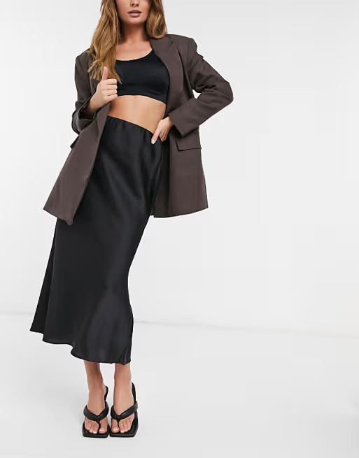 ASOS DESIGN satin bias slip midi skirt in black | ASOS (Global)