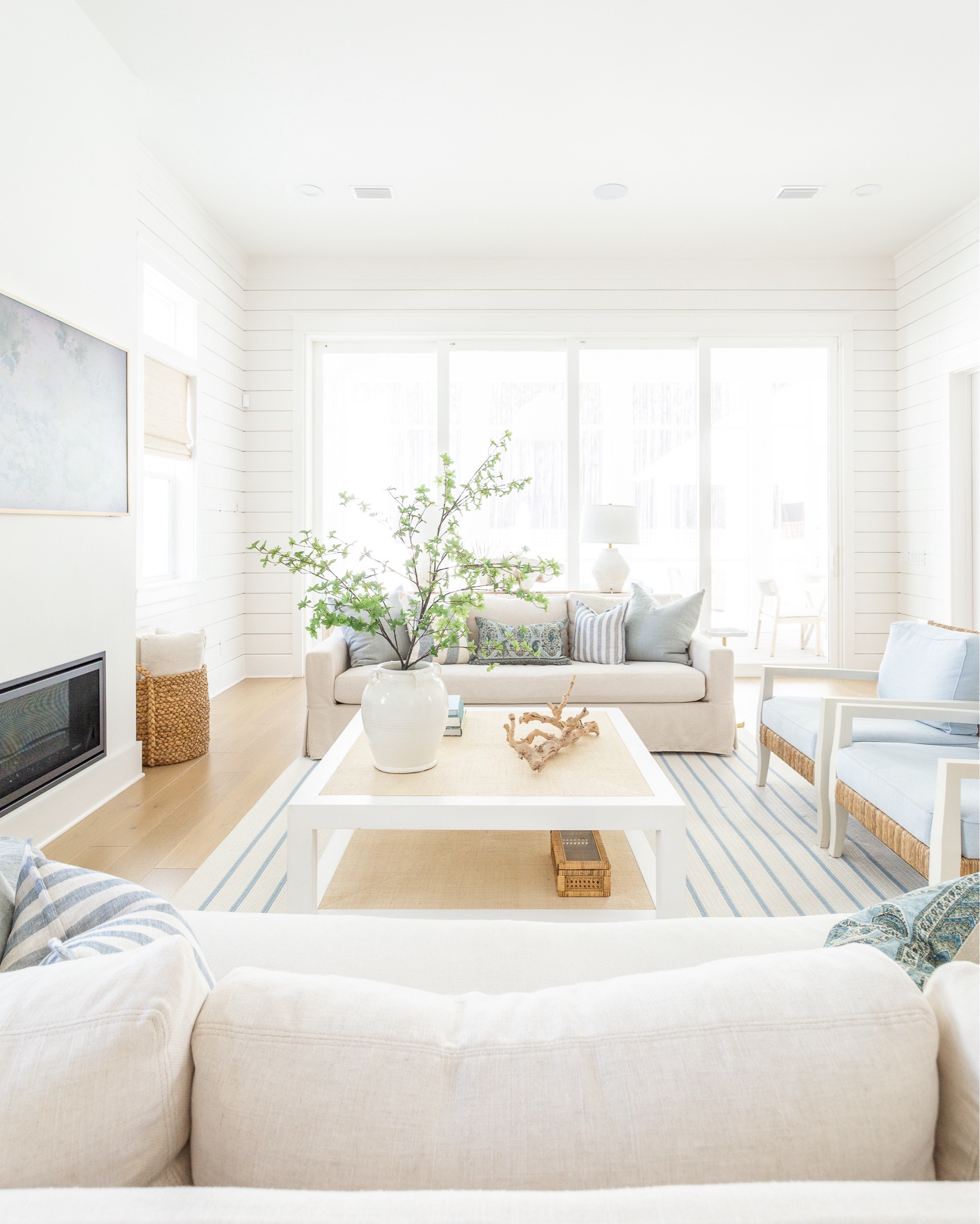 Our living room decorated for spring! Includes our favorite linen sofas, light blue linen armchairs, a blue and white striped rug, raffia coffee table, rope console table, white ceramic lamps, frame tv art for spring, a large greenery branch, blue linen pillows, paisley lumbar pillow, striped pillows, woven Roman shades, and more! See the full spring tour here: https://lifeonvirginiastreet.com/2024-spring-home-tour/.
.
#ltkhome #ltksalealert #ltkseasonal #ltkfindsunder50 #ltkfindsunder100 #ltkstyletip spring decor, spring living room, coastal decor, 

#LTKSeasonal #LTKVideo #LTKsalealert