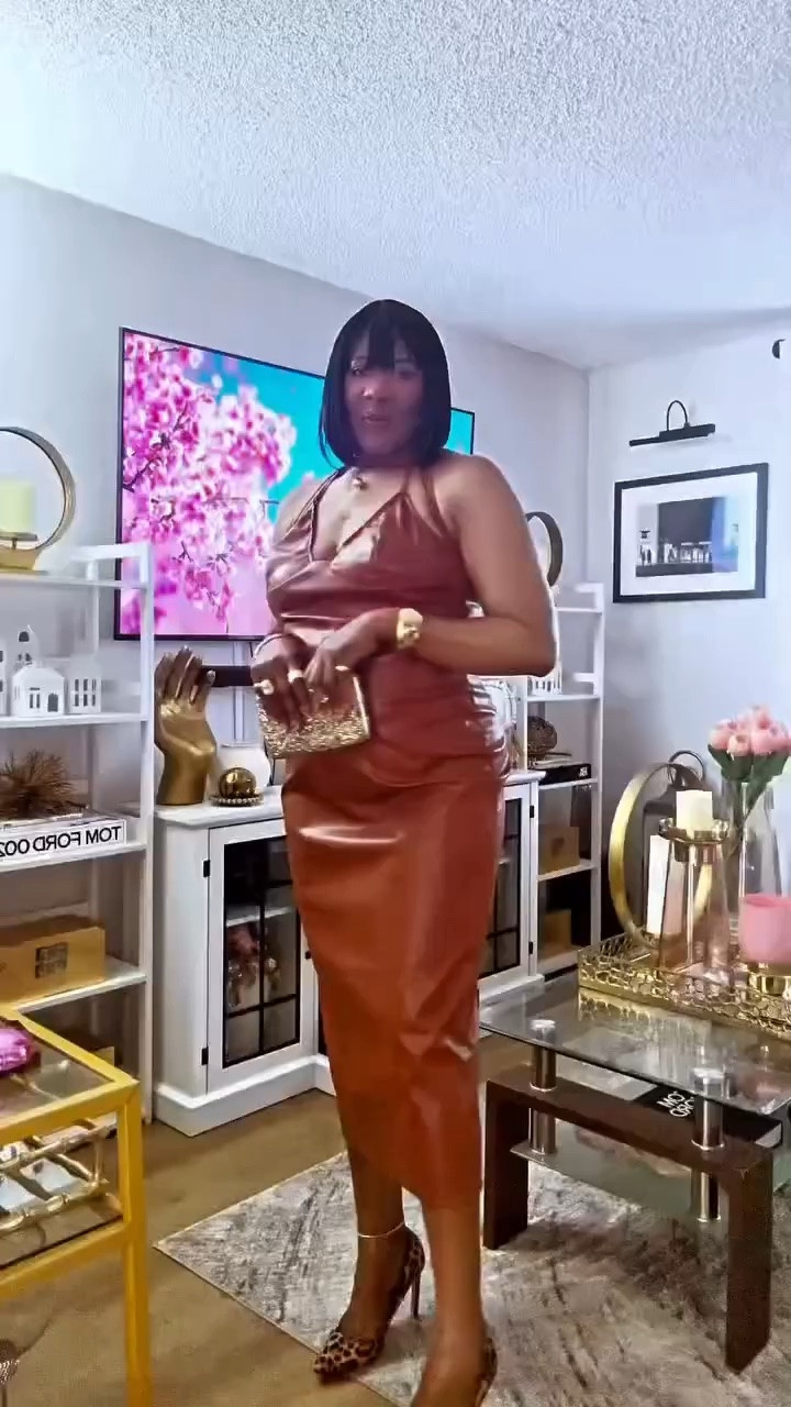 LEATHER WEATHER  cognac and caramel  complements my brown skin tone perfectly 🍂

There’s just something about brown on brown. This faux leather spaghetti straps dress, gold jewelry, leopard moment and a touch of YSL. 

Fall transition dressing, but make it rich.

Would you wear head-to-toe caramel?
 is 95 degrees outside, so I’m rocking a leather dress! 
 
Ladies it’s tall girls friend! 

faux leather halter dress, cognac leather dress, leather weather outfit, caramel skin tone fashion, brown on brown outfit, fall leather dress 2026, brown skin fall style