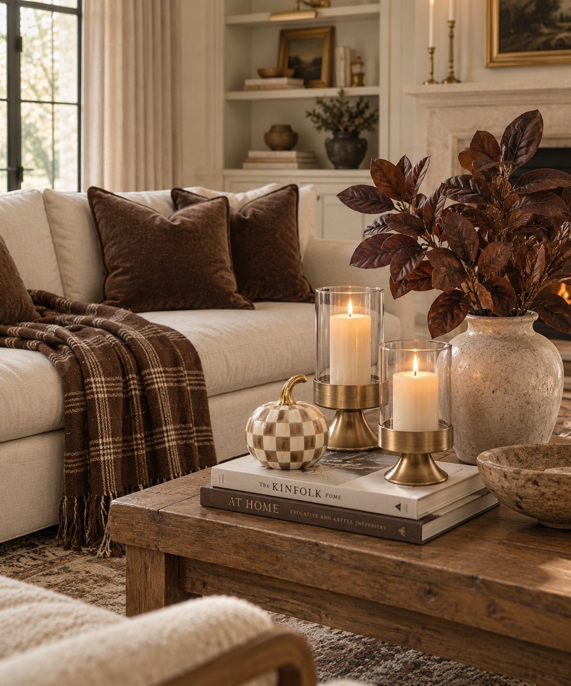 Cozy fall living room decor without covering the house in orange. 🤎 Chocolate brown velvet pillows, a plaid throw blanket, warm brass hurricane candle holders, a checkered pumpkin and rich brown magnolia stems bring warmth and texture to a neutral space. I love this mix for creating an elevated, collected fall look that still feels timeless enough to work throughout the season.

Amazon fall decor, fall home decor, neutral fall decor, brown fall decor, cozy fall decor, elevated fall decor, fall living room decor, fall living room ideas, Amazon home finds, Amazon decor finds, chocolate brown decor, brown velvet pillows, plaid throw blanket, fall throw blanket, hurricane candle holders, gold candle holders, brass home decor, checkered pumpkin, pumpkin decor, faux magnolia stems, fall floral stems, coffee table decor, fall coffee table decor, coffee table styling, warm neutral decor, cozy living room, neutral living room, transitional home decor, traditional home decor, collected interiors, designer inspired decor, affordable home decor, autumn home decor, seasonal home decor, subtle fall decor, elegant fall decor, sophisticated fall decor, warm home decor, fall decorating ideas, cozy home inspiration, fall styling ideas, living room styling, neutral home decor, brown home decor, textured home decor, fall accessories, Amazon fall finds, fall interior inspiration, cozy home finds, warm fall aesthetic

#LTKHome #LTKSeasonal #LTKSaleAlert