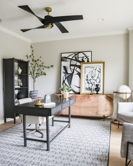 Sideboard styling in our modern masculine office! Try layering large art above a console or credenza piece like this to fill a blank wall!

office decor, large scale artwork, wall art, abstract art, modern ceiling fan, gray desk, bookcase

#LTKstyletip #LTKhome #LTKsalealert