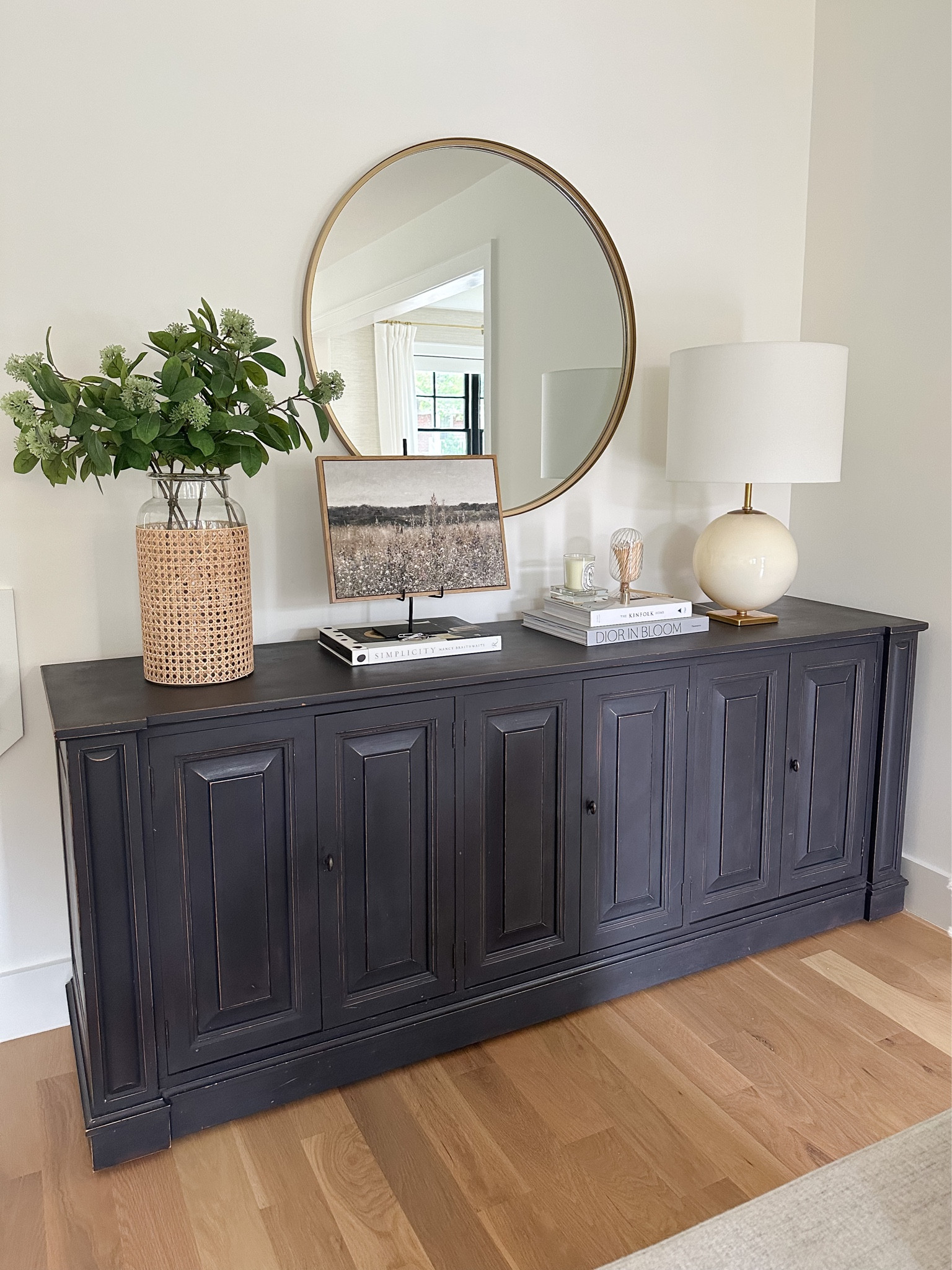 Dark gray buffet, sideboard, console styling, round brass mirror (34”) cream and brass table lamp, affordable fall art, cane vase, living room design, home decor, Amazon home, Amazon finds 

#LTKhome #LTKFind #LTKSeasonal