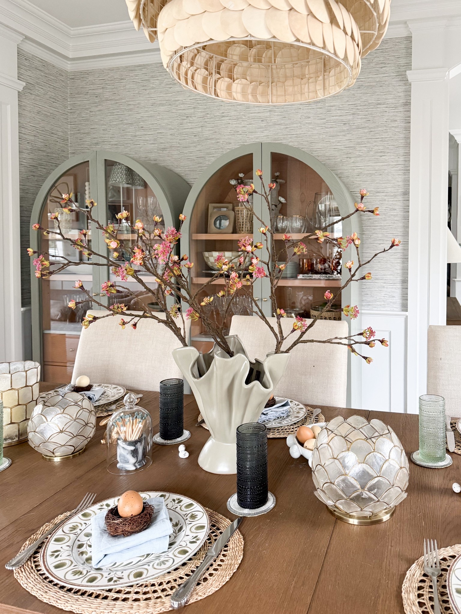 Easter and spring tablescapes inspo! If you’ll be entertaining this spring, I have some really fun ideas for you! I love to create a pretty seasonal tablescape using dinnerware, table linens, flowers and accessories that I already own. I grabbed a few new ones for Easter (that ship fast!!) and incorporated other items that I own and love all year long 🩶

Easter tablescape, spring entertaining, flowers, spring vase, spring decor, Anthropologie arched cabinets, grasscloth wallpaper, Serena & Lily chandelier 

#LTKSeasonal #LTKdayinmylife #LTKHome