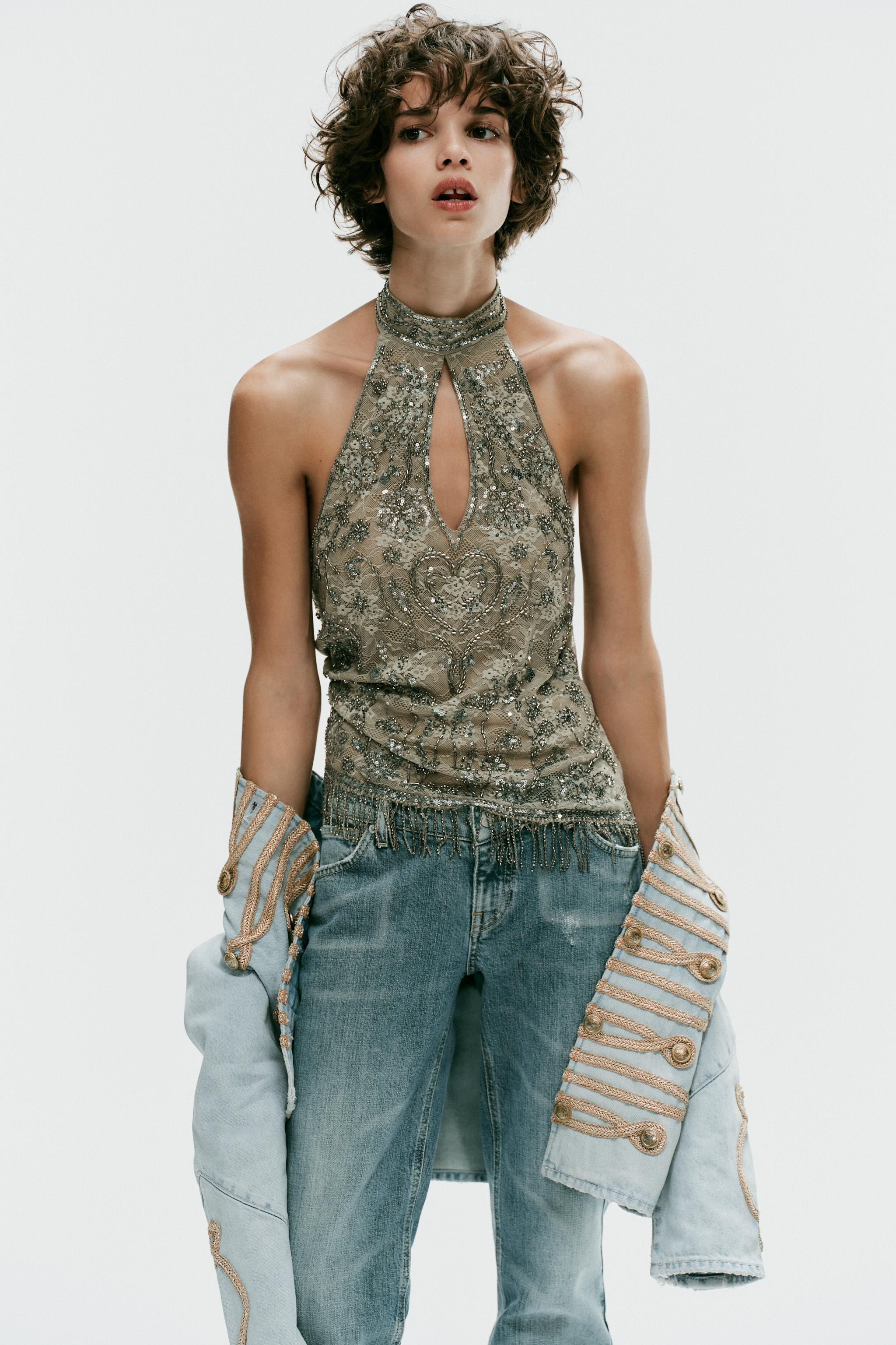 Model height: 176 cmTop crafted from a polyamide blend. Features a cut-out halter neck and open b... | Zara UK