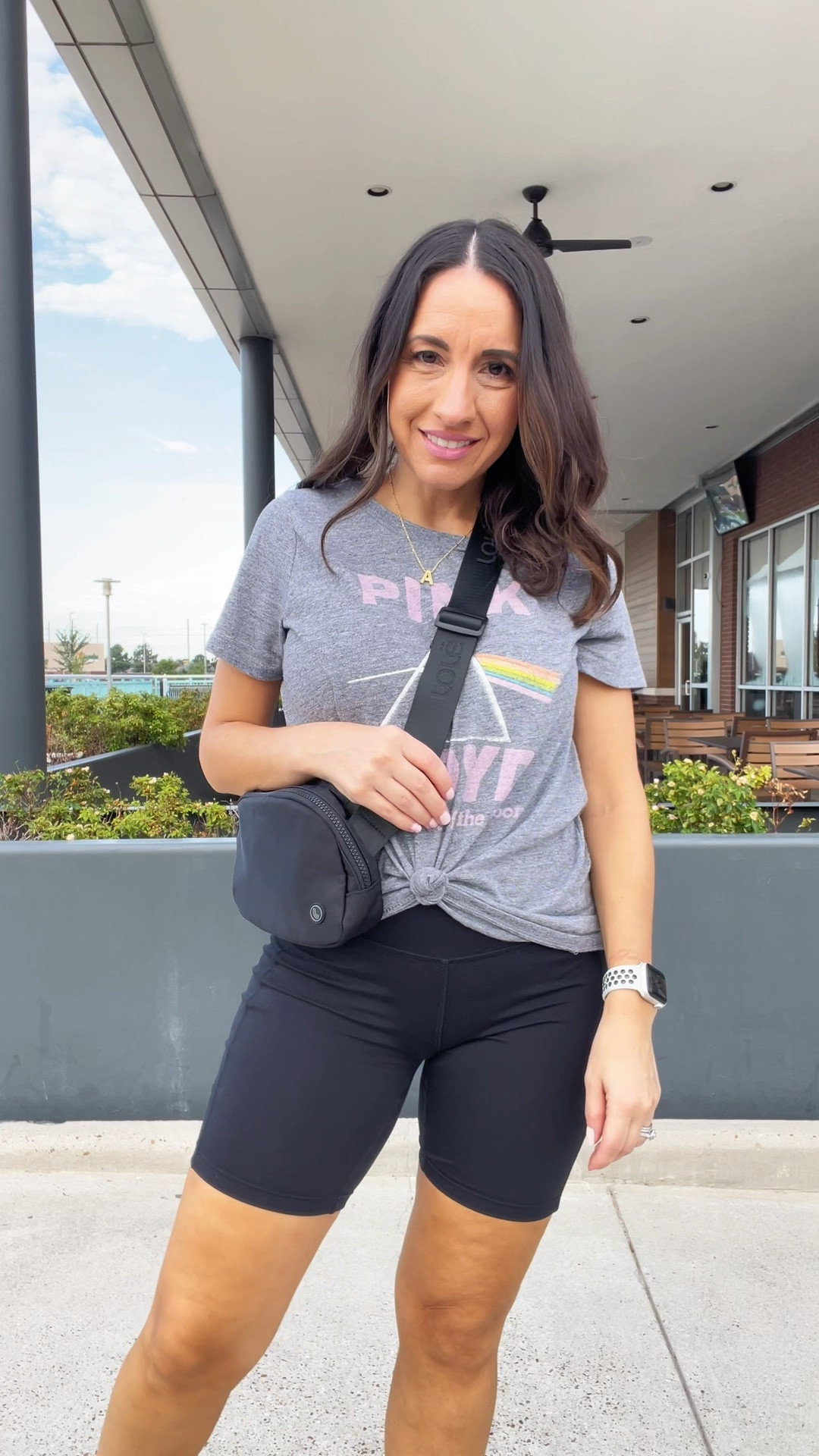 Casual style. 
Band tshirt, biker shorts, belt bag, and cute sneakers. 
Petite style 
Petite outfit 

#LTKPetite #LTKOver40 #LTKSeasonal