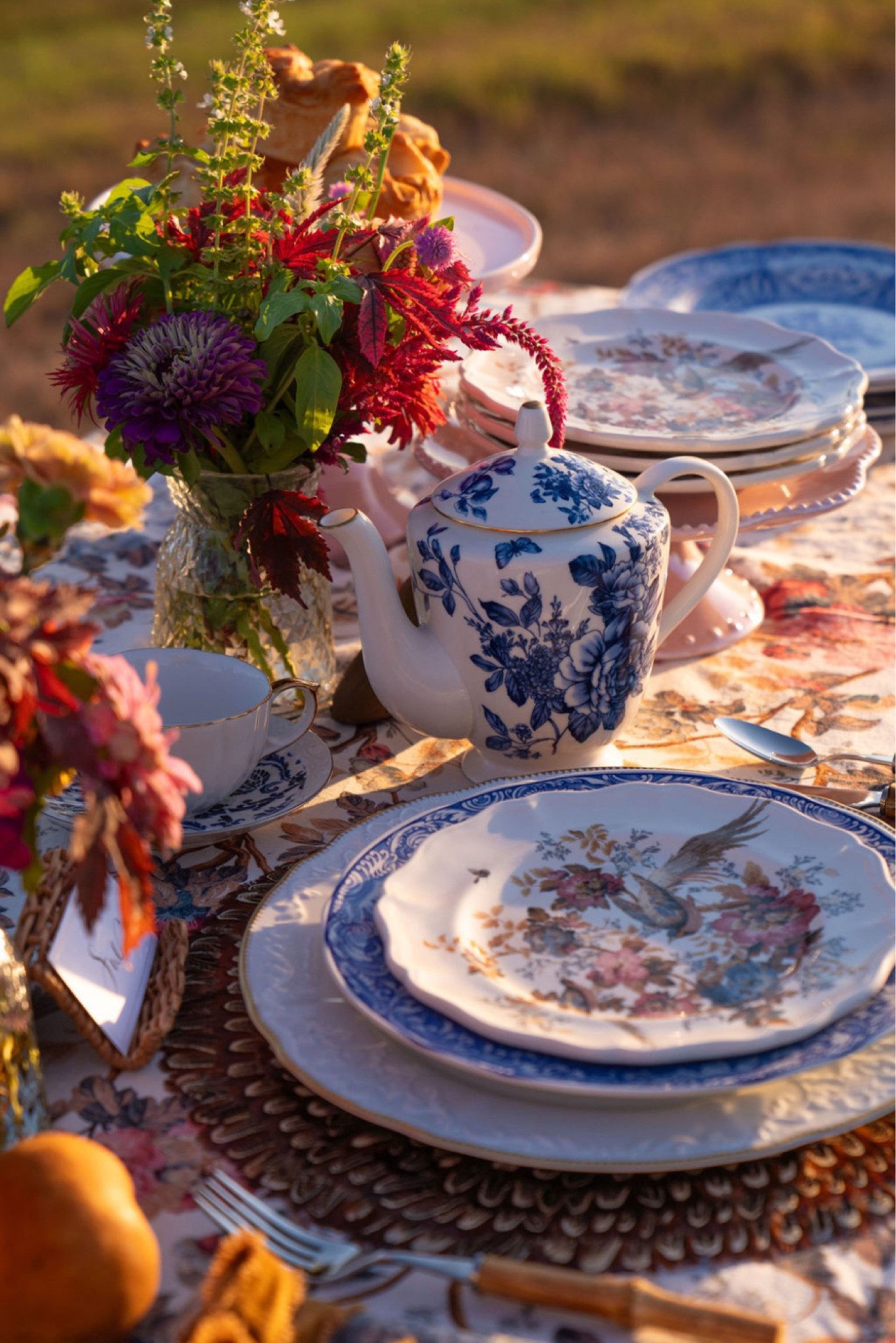 Fall is the best time of year for Al fresco dining and this beautiful blue, white, and bronze fall harvest Tablescape will surely impress. Decorate your table with florals this fall and elegant blue and white tableware. A printed floral table cloth is also necessary! BLUE AND WHITE TABLESCAPE. BLUE AND WHITE PLACE SETTING. BLUE AND WHITE CHINA. BLUE AND WHITE PLATES. FLORAL TABLE DECOR. FLORAL TABLE CLOTH. FALL HARVEST TABLE. FALL HARVEST TABLE SETTING. 

#LTKhome #LTKHoliday #LTKSeasonal