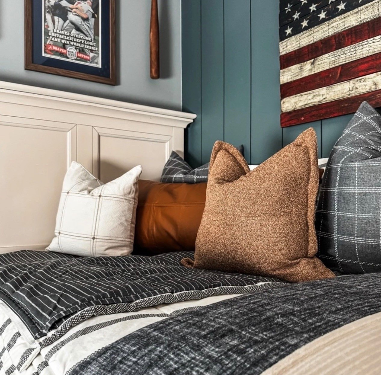 Layered, cozy, and full of character 🤍 This bed styling mixes neutral bedding with plaid throw pillows, a leather lumbar pillow, and textured accent pillows for a warm, lived-in look. The striped quilt, dark charcoal coverlet, and tailored pillow shams add depth, while the painted shiplap wall, wood headboard, and Americana wall art bring in classic, masculine charm. A perfect blend of traditional bedroom design and everyday comfort.

#eanesinteriors #bedroominspo #bedroomdecor #bedstyling #layeredbedding #throwpillows #plaidpillows #leatherpillow #neutralbedding #stripedquilt #charcoalbedding #shiplapwall #traditionalhome #ltkhome #cozyinteriors

#LTKHome #LTKSeasonal #LTKOver40