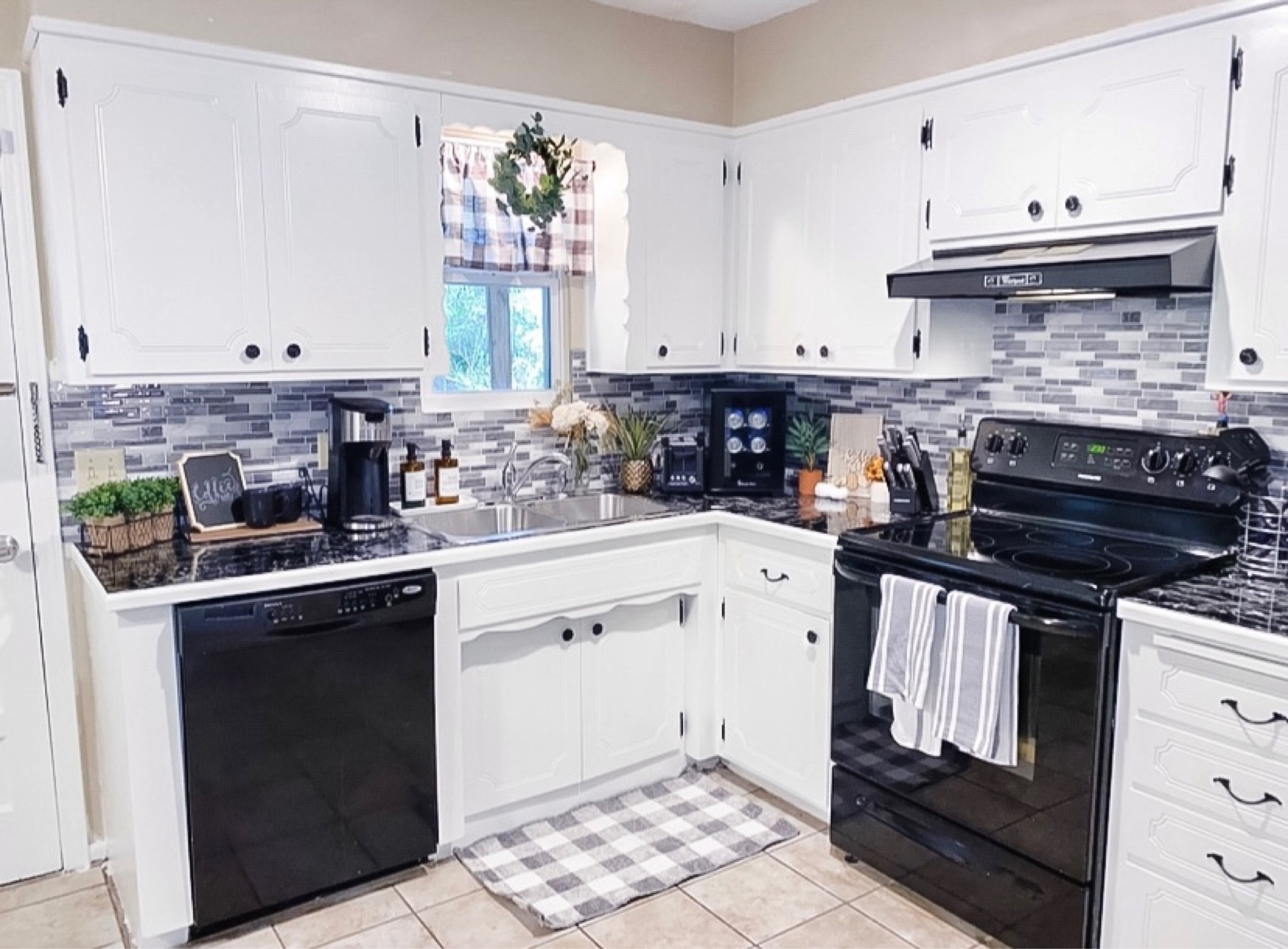 Old picture right after my DIY kitchen makeover! Repainted the cabinets white and used peel and stick for new backsplash and countertops 🤍🖤

#LTKhome #LTKstyletip