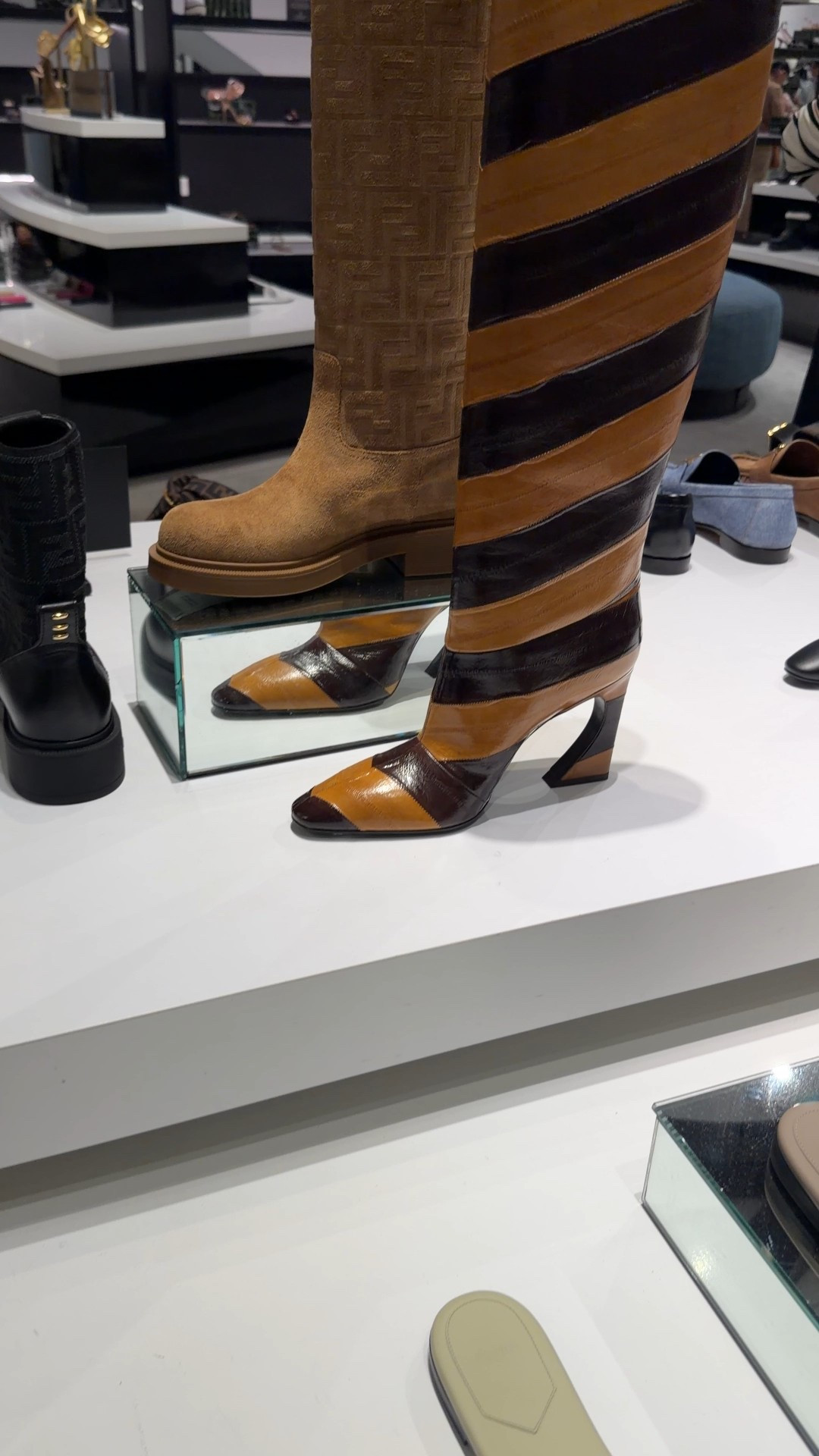 Tubular Fendi boots with tapered toe and high heel featuring the iconic Arco line, customized with metal detail and engraved logo. Made of glossy hagfish leather, inlaid to create a chevron motif in light and dark brown.
Features

Fits true to size, order your normal size
Tapered toe
Pull-on style
Glossy hagfish leather, inlaid for a chevron design
Metal detail and engraved logo
3.74" high heel
Hagfish leather upper, leather lining and sole
Made in Italy

#fendi #fendiboots #footwear #elevatedstyle

#LTKgrwm #LTKootd #LTKValentine