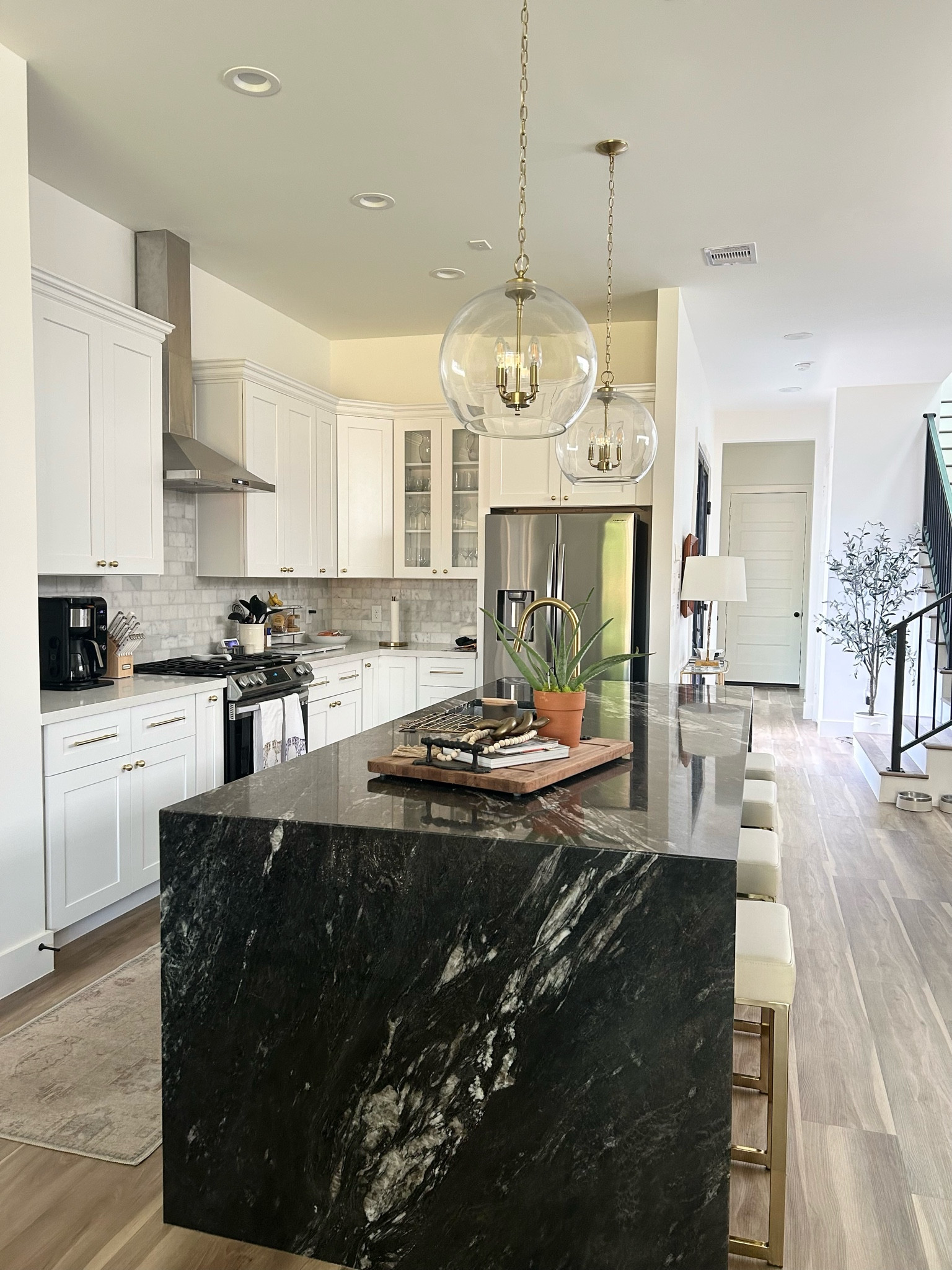 Our kitchen ✨ 

Moody Kitchen. Titanium island. Marble backsplash. Marble subway tiles. Wayfair. Home Depot. Rugs USA. Glass pendant lights. Globe pendant lights. Gold pendant lights. White barstools. Backless barstools. White and gold barstools. Set of 2 barstools. Family kitchen. Gold hardware. Interior design. Kitchen interior. Gold faucet. Kitchen update. 

#LTKhome