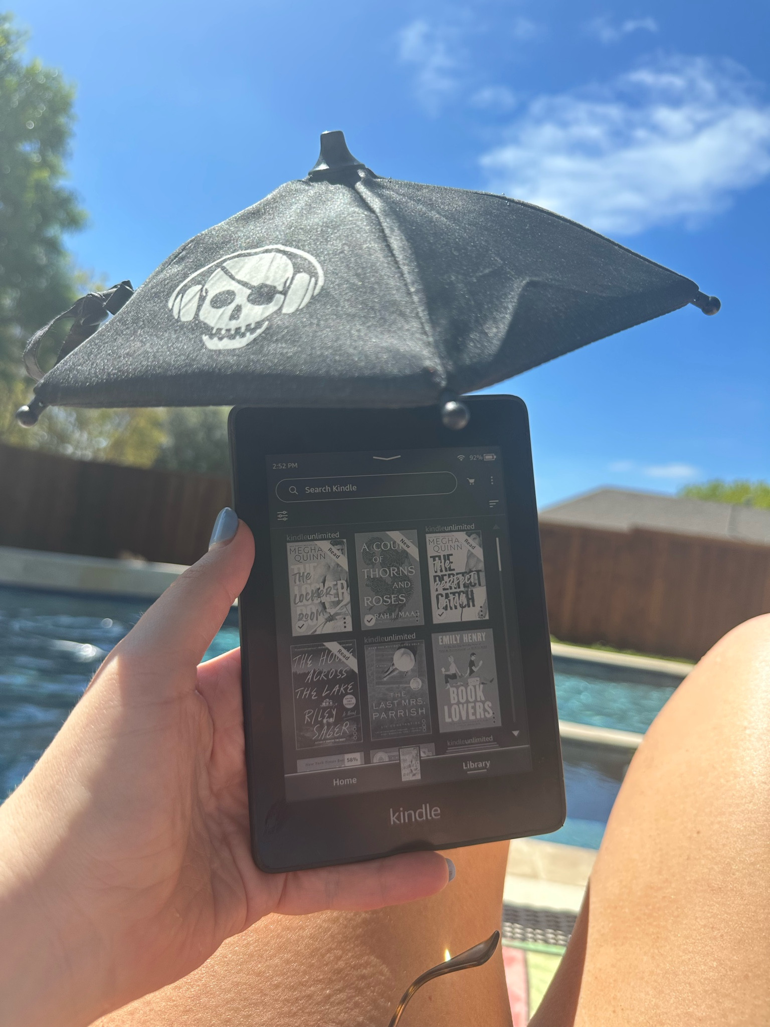 Kindle and kindle umbrella perfect for reading by the pool or at the beach! The umbrella also works on your phone to provide shade on the screen to see better and keep it from over heating. This is a great Mother’s Day gift idea for moms who like to read! #pool #beach #reading #read #books 

#LTKunder50 #LTKGiftGuide #LTKFind