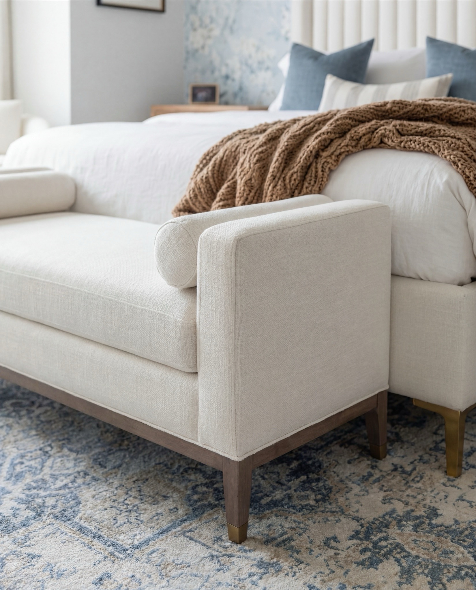 Shop the Look: Bedroom Refresh
• Blue floral wallpaper (soft watercolor style)
• Exposed wood ceiling beams
• White globe pendant light with brass chain
• Brass wall sconces with globe shades
• Upholstered bed frame (ivory fabric)
• White duvet + sheet set
• Blue patterned accent pillows
• Solid neutral throw pillows
• Wood nightstands (light oak tone)
• Blue ceramic urn-style vase
• White sculptural ceramic bowl
• Wooden bead garland with tassel
• Framed floral artwork above bed
• Upholstered bench at foot of bed (cream)
• Patterned area rug (blue and ivory tones)
• Light wood flooring
• Knit throw blanket (warm neutral)

#LTKHome #LTKSaleAlert