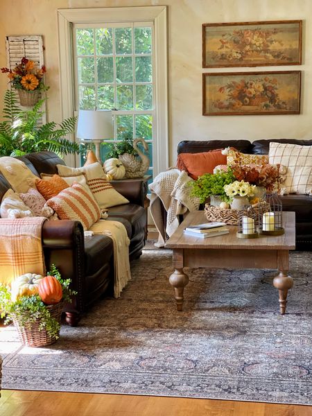 Vintage farmhouse living room in fall. Fall decor, leather sofa, throw pillows, throw blankets, area rug, vintage prints, pumpkins

#LTKsalealert #LTKSeasonal #LTKhome