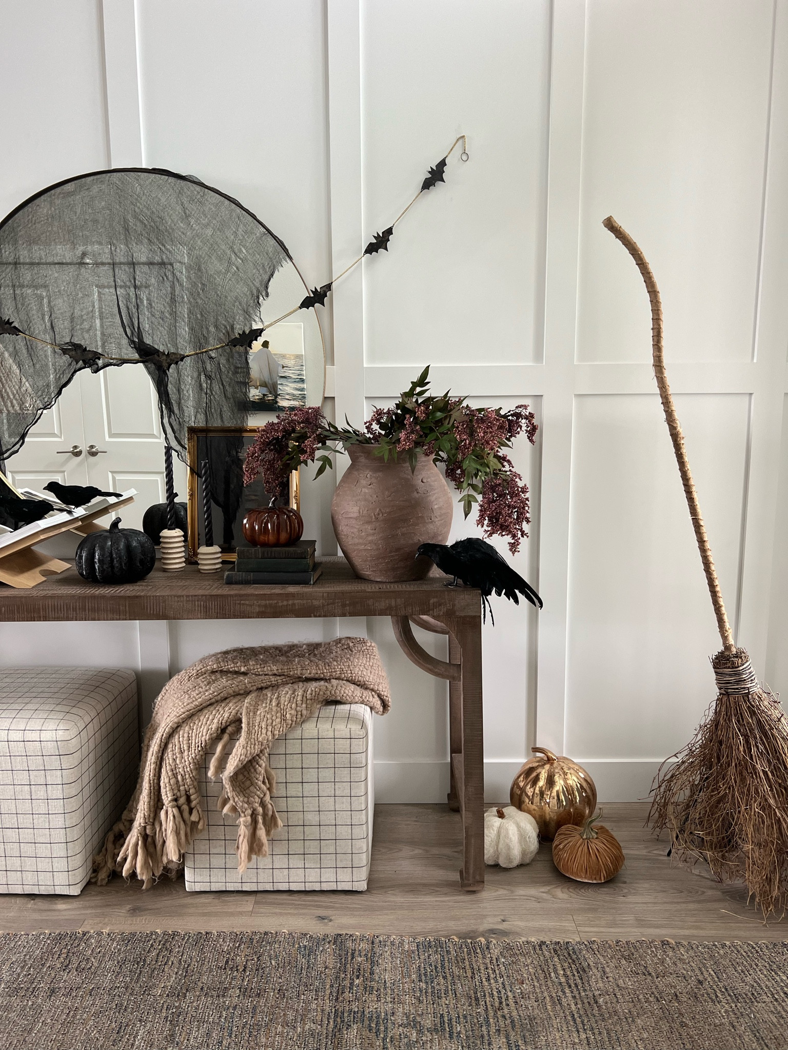 Halloween but make it classy!

Fall entryway, crows, console table, broom, pumpkins, ottomans, mirror, spooky, Halloween decor