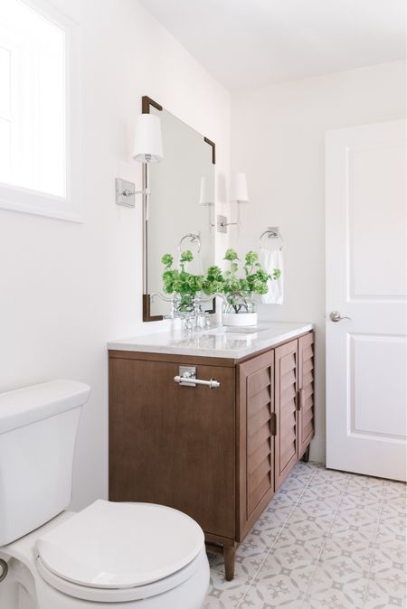 All the details of our small guest bathroom remodel in Omaha! Items include a louvered wood vanity with a Carrara marble countertop, chrome bath faucet, mirror with bracket corners, paint dipped vase with faux viburnum stems, silver wall sconces, and chrome bathroom hardware. See even more details here: https://lifeonvirginiastreet.com/small-guest-bathroom-remodel-reveal/

.
Amazon home decor, target home, target finds, mcgee and co mirror, studio mcgee mirrors, amazon faucets, amazon bathroom accessories, bathroom vanity lighting, wall sconce, bathroom faucet, bathroom flooring, bathroom ideas, bathroom inspiration, amazon bathroom, bathroom hardware, bathroom accessories, bathroom remodel, cement tile, wood vanities, white bathroom, wall sconces, chrome light fixtures 

#ltksalealert #ltkhome #ltkfindsunder50 #ltkfindsunder100 #ltkstyletip #ltkseasonal #ltkkids #ltkfamily 


#LTKSeasonal #LTKHome #LTKSaleAlert