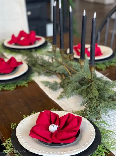 Festive tablescape idea with a fun napkin fold, faux greenery, candles and layered place settings of black and white 

#LTKHoliday #LTKSeasonal #LTKhome