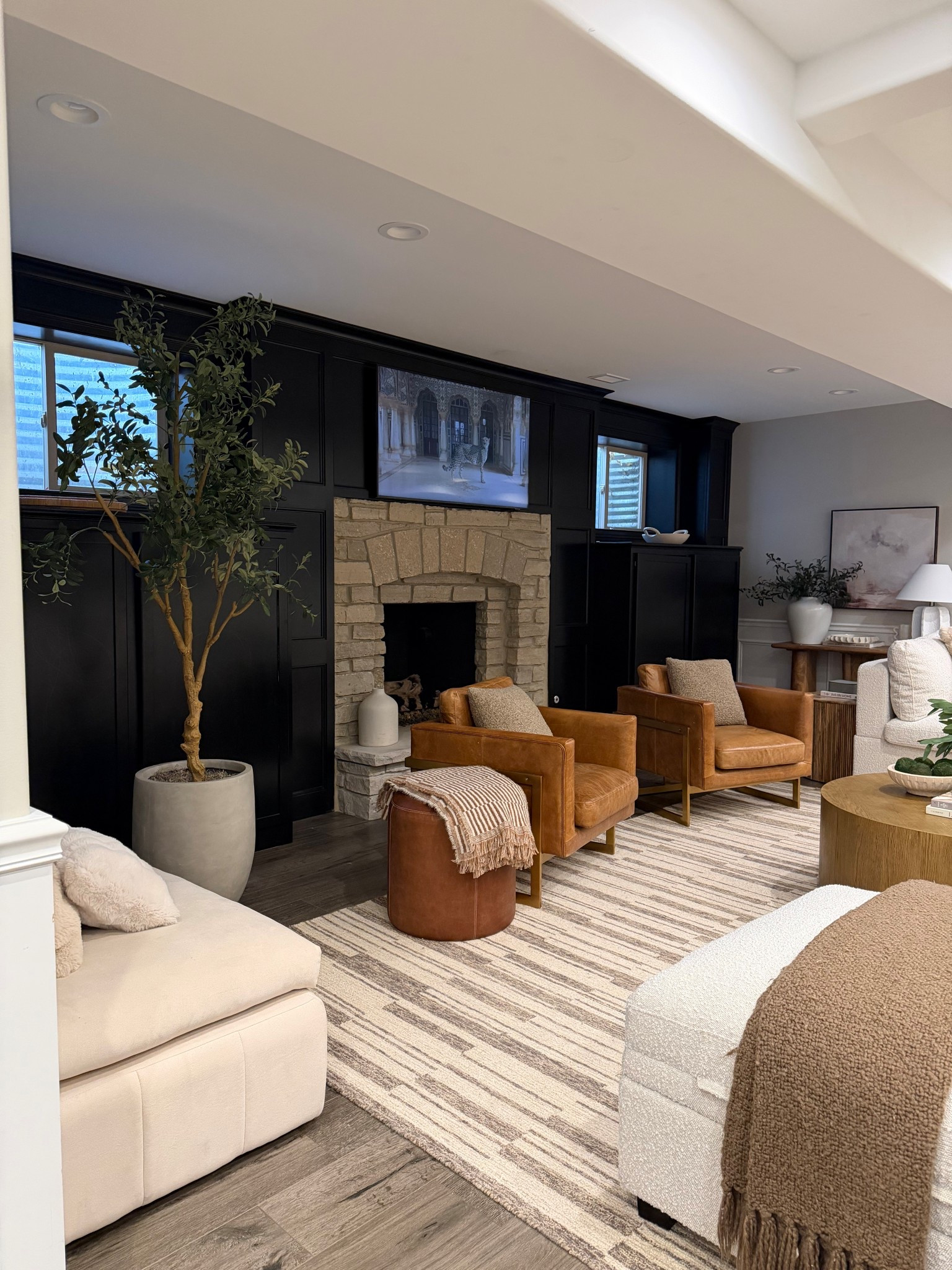 A little reading corner by the fireplace.
Linking the leather accent chairs, side table, lamp, and rug that warm up the space.

#LTKHome