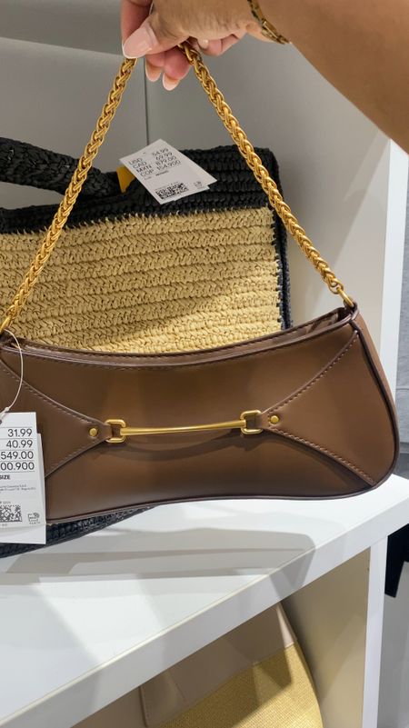 H&M 

New Arrival
Small bag with a decorative horsebit detail at front. Short shoulder strap in metal chain and a zipper at top. Lined. Depth 11/2 in. Height 43/4 in. Width 10 1/2 in.

Weight: 226 g
Size: Height: 4.7 in, Width: 11 in, Depth: 1.6 in Accessory Type: Shoulder Bag
Description: Dark brown/gold-colored

#LTKItBag #LTKStyleTip #LTKBeauty
